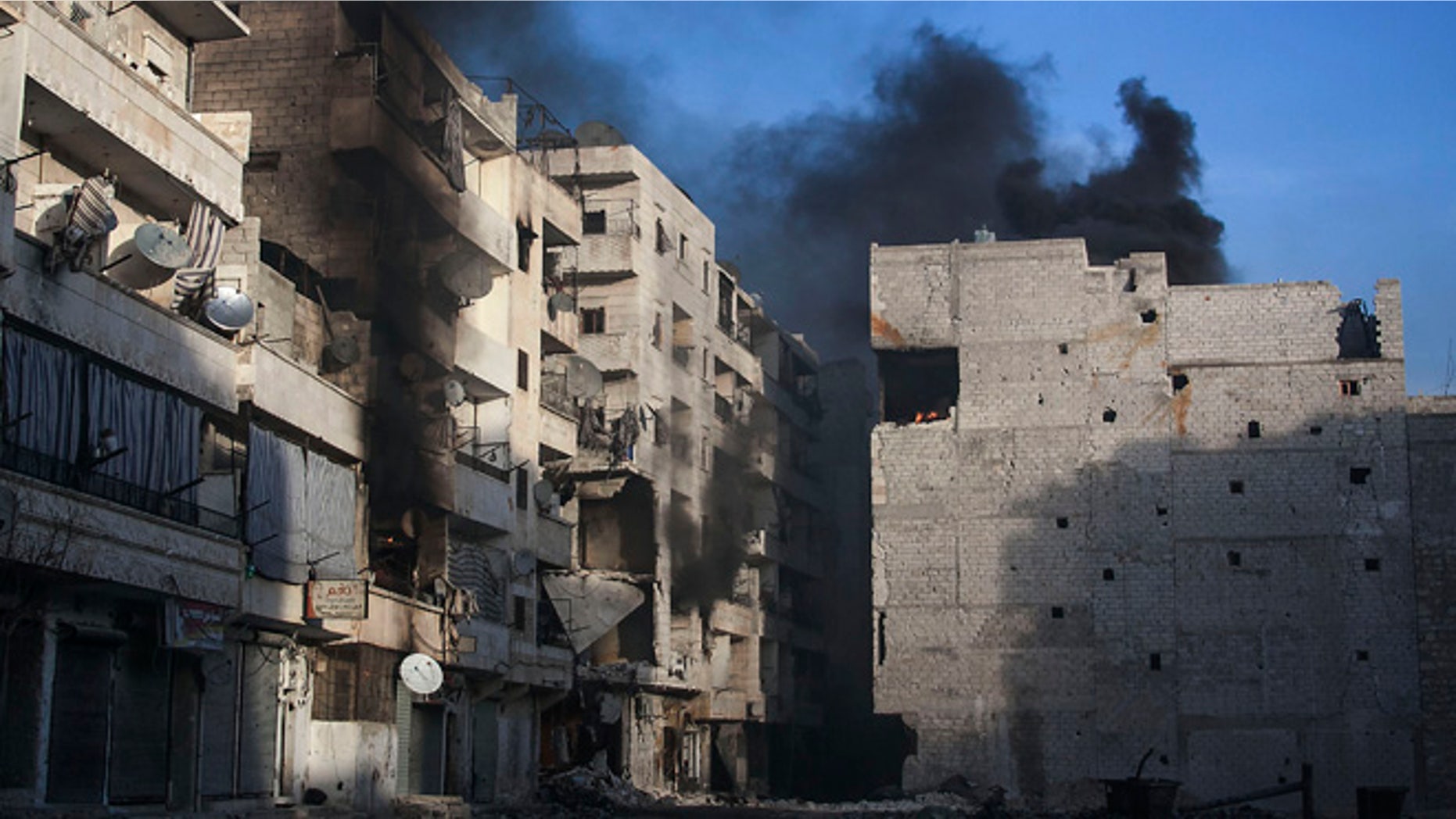 Dec. 5, 2012: Smoke rises from residential buildings due heavy fighting between Free Syrian Army fighters and government forces in Aleppo, Syria.