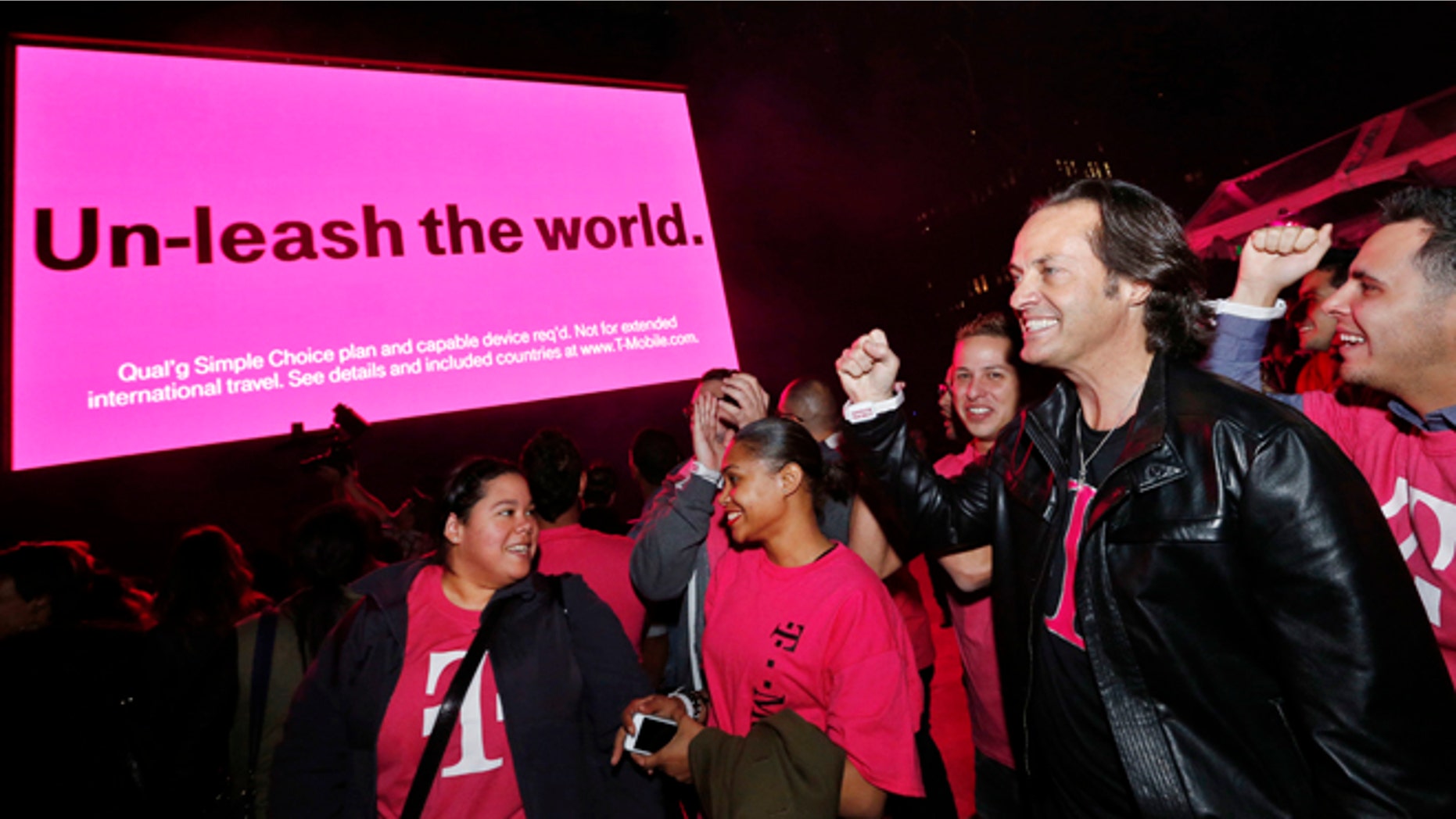 IN THIS IMAGE DISTRIBUTED BY AP IMAGES FOR T-MOBILE - T-Mobile CEO John Legere celebrates the end of international data roaming fees at a special event for customers with Shakira in New York's Bryant Park on Wednesday, Oct. 9, 2013. T-Mobile has extended unlimited data and texting to Simple Choice customers traveling in more than 100 countries. (Jason DeCrow/AP Images for T-Mobile)