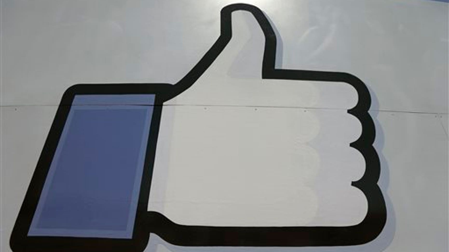 This June 11, 2014, photo shows Facebook's "like" symbol at the entrance to the company's campus in Menlo Park, Calif. (AP Photo/Jeff Chiu)