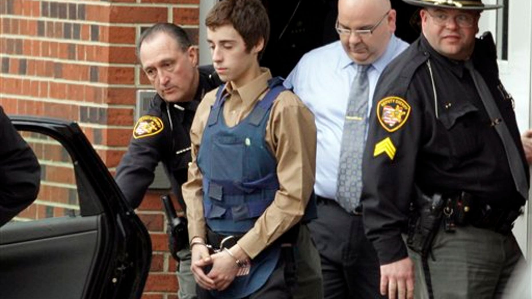 Feb. 28: T.J. Lane, 17, is led from Juvenile Court by Sheriff's deputies in Chardon, Ohio, after his arraignment in the shooting of five high school students Monday. Three of the five students wounded in the attacks have since died.