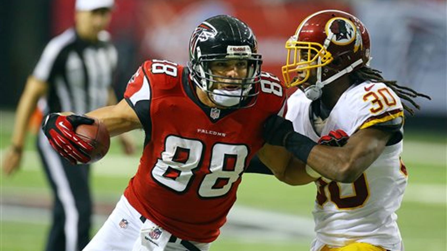 Atlanta Falcons tight end Tony Gonzalez (88) catches a pass against Washington Redskins cornerback E.J. Biggers during the second half of an NFL football game on Sunday, Dec. 15, 2013, in Atlanta. (AP Photo/Atlanta Journal-Constitution, Curtis Compton) MARIETTA DAILY OUT, GWINNETT DAILY POST OUT) LOCAL TV OUT (WXIA, WGCL, FOX 5)