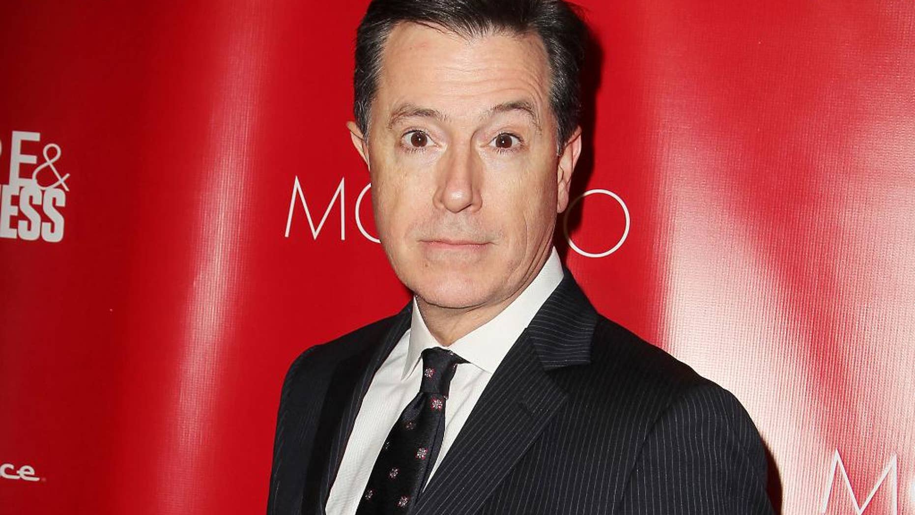 FILE - This Jan. 31, 2014 file image released by Starpix shows Stephen Colbert at the Shape Magazine and Men's Fitness Super Bowl Party in New York. Colbert will not only be following in David Letterman's footsteps, he'll be doing it on the same stage. CBS said Wednesday, July 23, that Colbert, who is replacing Letterman as the "Late Show" host next year, will keep the show in New York City's Ed Sullivan Theatre. Colbert's debut date is still uncertain, dependent on when Letterman officially retires from late-night TV. (AP Photo/Starpix, Amanda Schwab, File)