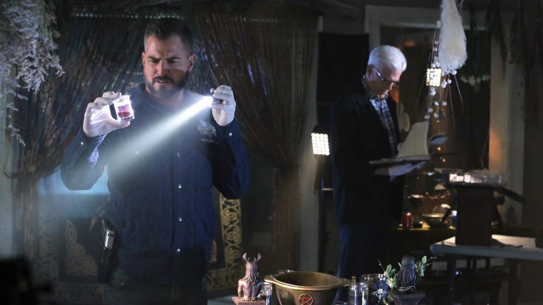 In this image released by CBS, George Eads, left, and Ted Danson appear in a scene from "CSI: Crime Scene Investigation." "CSI," which debuted in 2000, will wrap with a two-hour finale on Sept. 27. Original cast members including William Petersen and Marg Helgenberger are returning for the send-off. (Michael Yarish/CBS via AP)