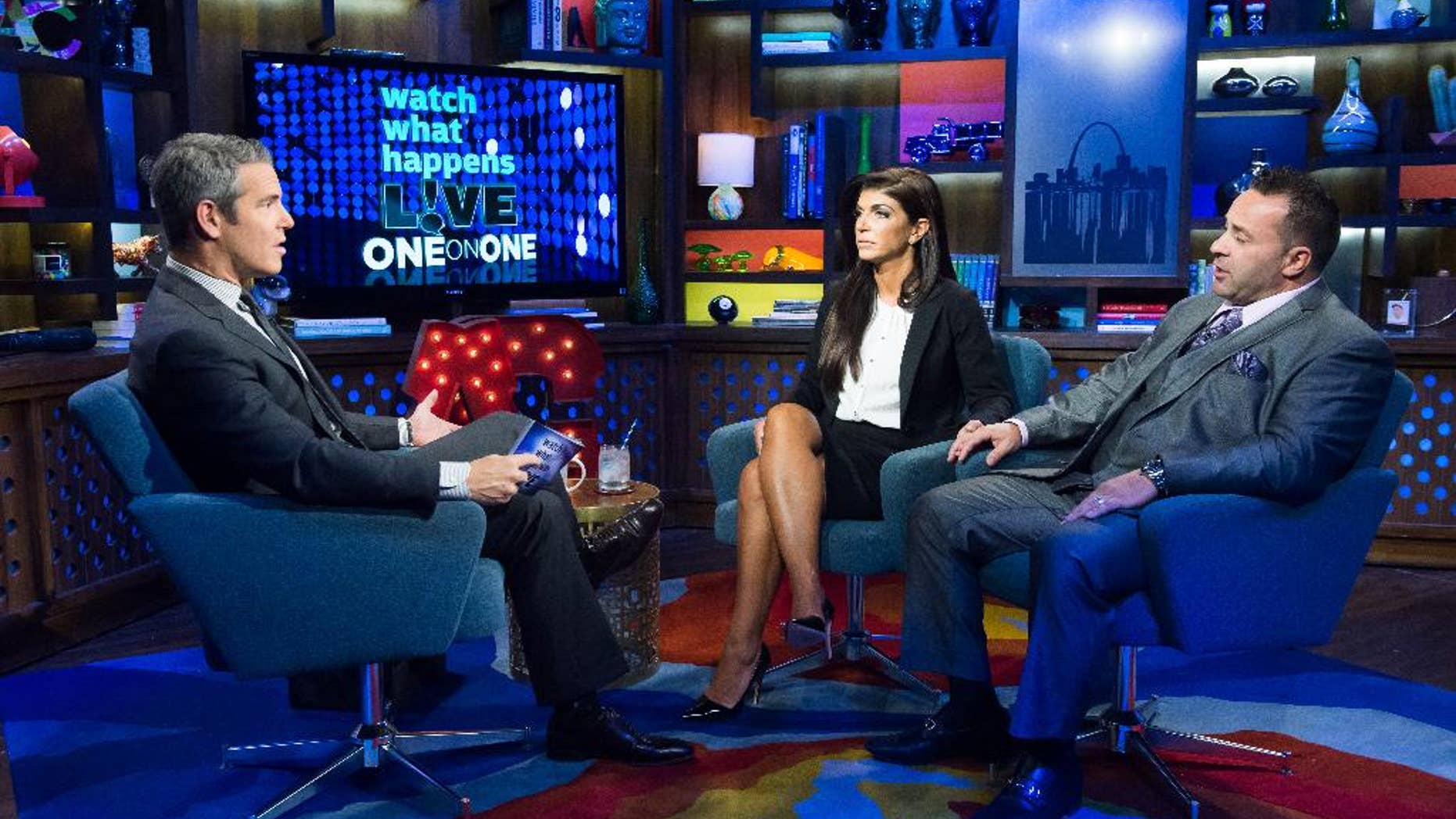 In this image released by Bravo shows host Andy Cohen, left, speaks with Teresa Giudice, and her husband Joe Giudice, cast members on "The Real Housewives of New Jersey," during a taping of "Watch What Happens Live," airing Monday, Oct. 6, 2014 on Bravo. Teresa was sentenced to 15 months in prison on conspiracy and bankruptcy charges and Joe was sentenced to 41 months last Thursday in federal court in Newark, N.J. (AP Photo/Bravo, Charles Sykes)