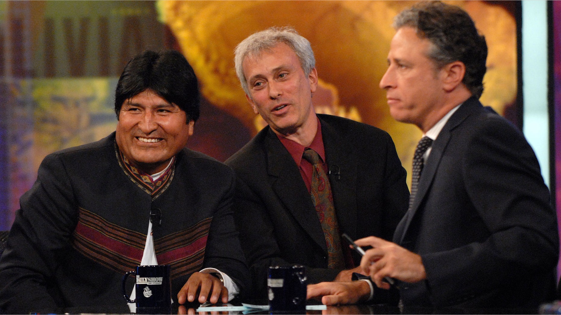 FILE - In this Sept. 25, 2007 file photo, Bolivian President Evo Morales, left, speaks with host Jon Stewart, right, as an interpreter looks on, during a taping of Comedy Central's "The Daily Show with Jon Stewart" in New York. Morales, a poor farmer, became the country's first indigenous president and assumed office in 2006. After more than 16 years and nearly 2,600 telecasts, Stewart will end his show on Aug. 6. (AP Photo/Peter Kramer, FIle)