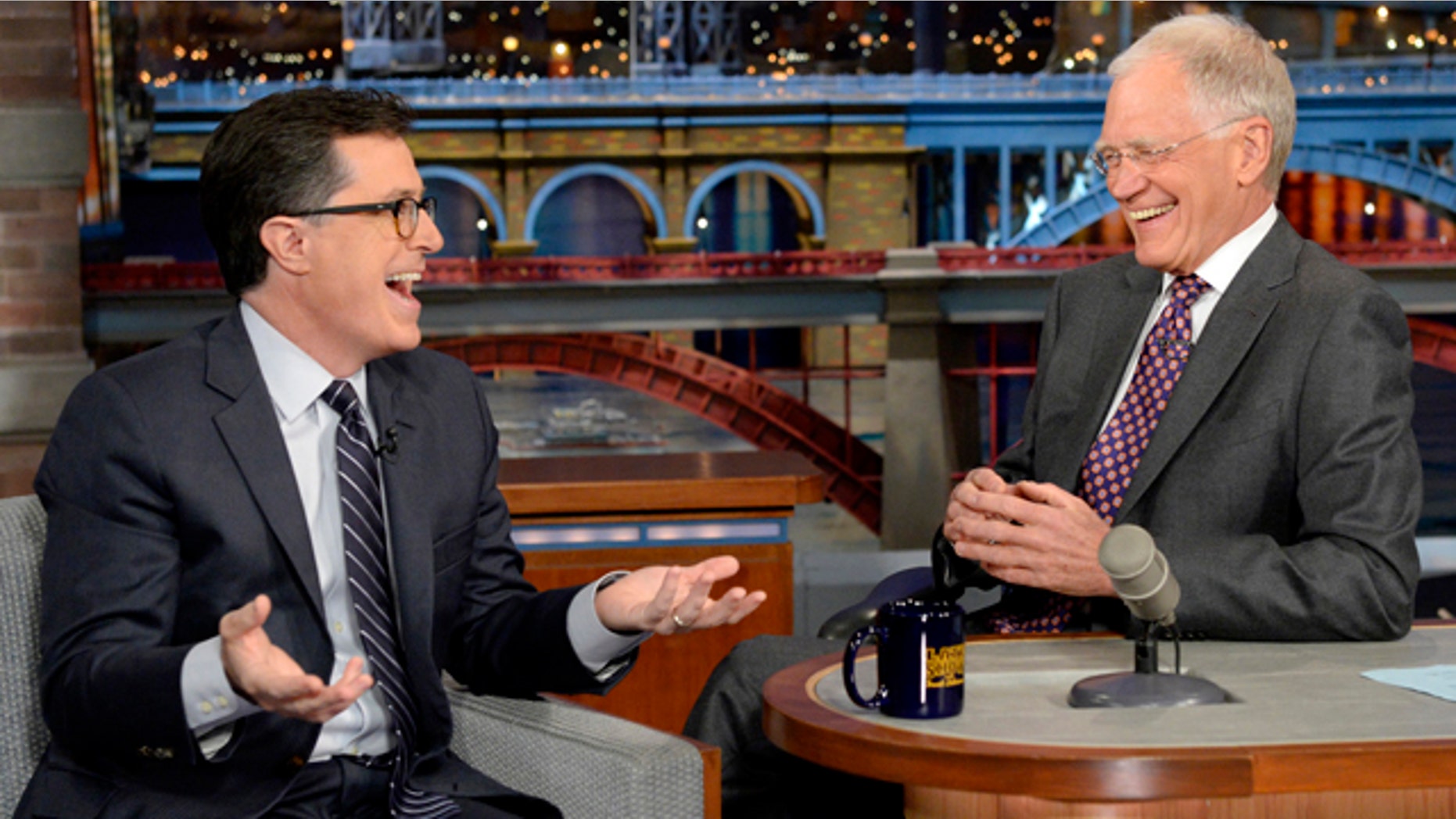 April 22, 2014: In this photo provided by CBS, Comedy Central's Stephen Colbert, left, joins host David Letterman on the set of 'The Late Show with David Letterman.' This was Colbert's first visit to the show since CBS announced that he will succeed Letterman as host when he retires in 2015. (AP Photo/Jeffrey R. Staab)