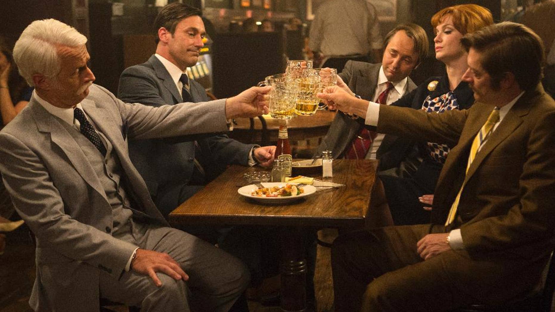 This image released by AMC shows, from left, John Slattery as Roger Sterling, Jon Hamm as Don Draper, Vincent Kartheiser as Pete Campbell, Christina Hendricks as Joan Harris and Kevin Rahm as Ted Chaough, in a scene from the final season of "Mad Men." The series finale airs on Sunday. (Justina Mintz/AMC via AP)