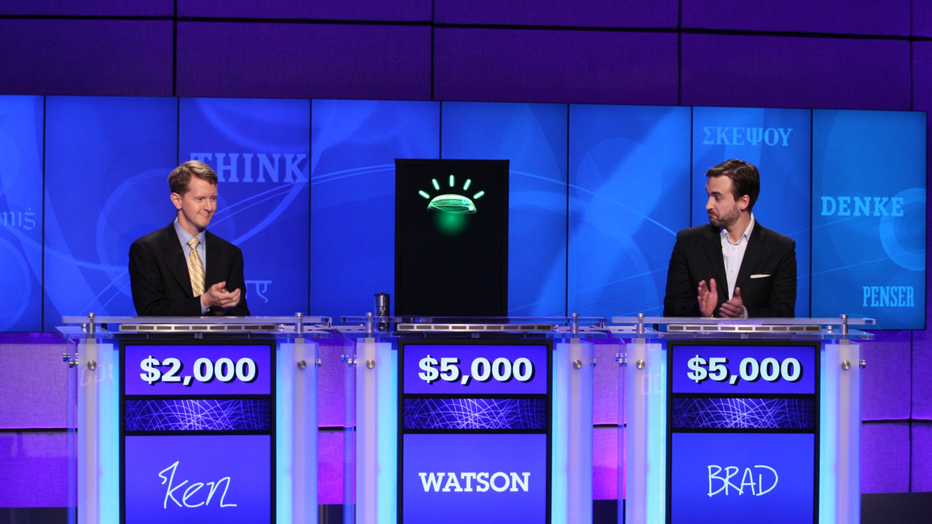 In this undated publicity image released by Jeopardy Productions, Inc., contestants Ken Jennings, left, and Brad Rutter and a computer named Watson compete on the game show 'Jeopardy!' in Yorktown Heights, N.Y. (AP)