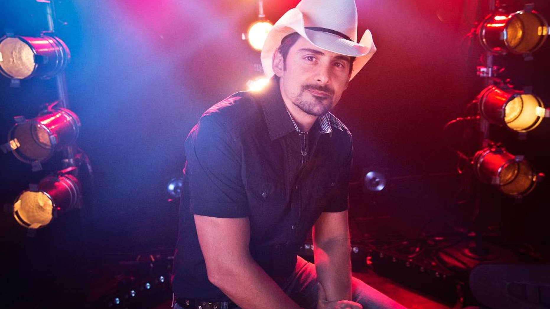 FILE - In this Aug. 28, 2014 file photo, country musician Brad Paisley poses for a portrait in New York. Paisley is joining “The Voice” this season as an adviser to help fellow country singer Blake Shelton. Paisley will help Shelton mentor his contestants on Team Blake in the competition show that begins Sept. 21 on NBC. (Photo by Amy Sussman/Invision/AP, File)