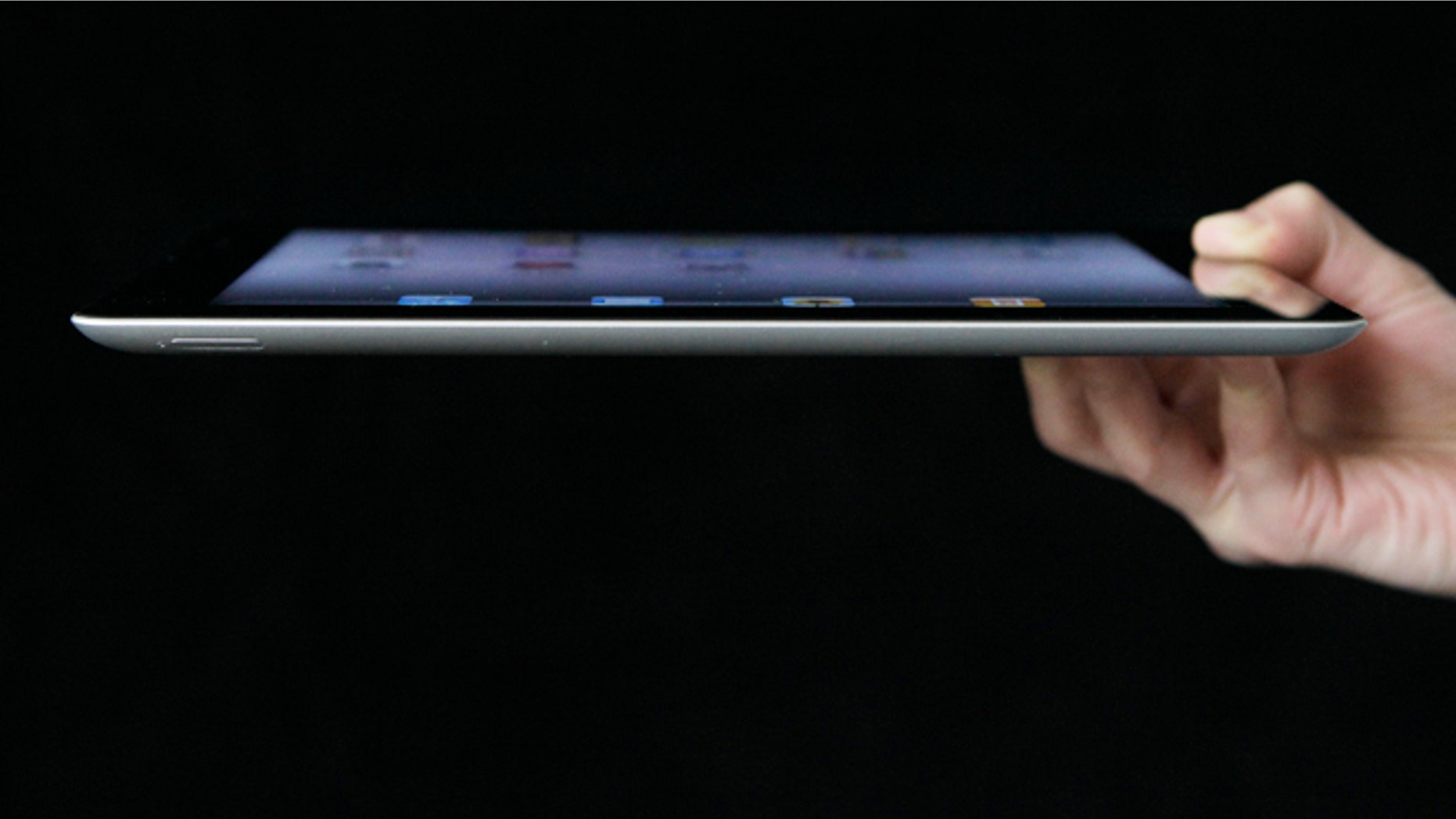An Associated Press reporter demonstrates Apple's iPad 2 in San Francisco.