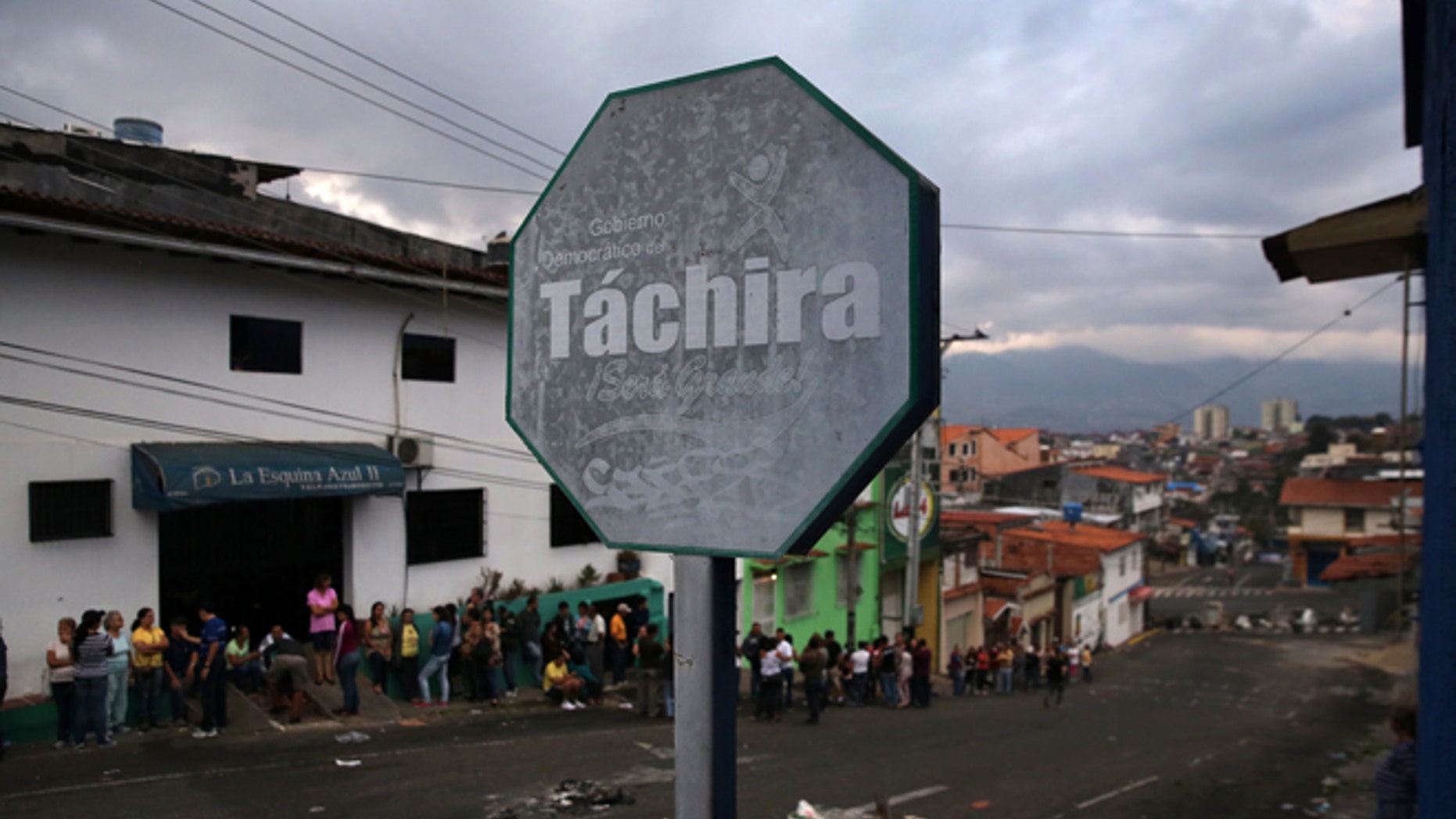 SAN CRISTOBAL, VENEZUELA - MARCH 09: A line of people queue to buy basic foodstuffs at dawn on March 9, 2014 in San Cristobal, the capital of Tachira state, Venezuela. People often start lining up before 5am to buy items like flour, milk and sugar, which are rationed and in short supply, especially in Tachira, which borders Colombia. Tachira has been a focal point for anti-government protests nationwide. (Photo by John Moore/Getty Images)