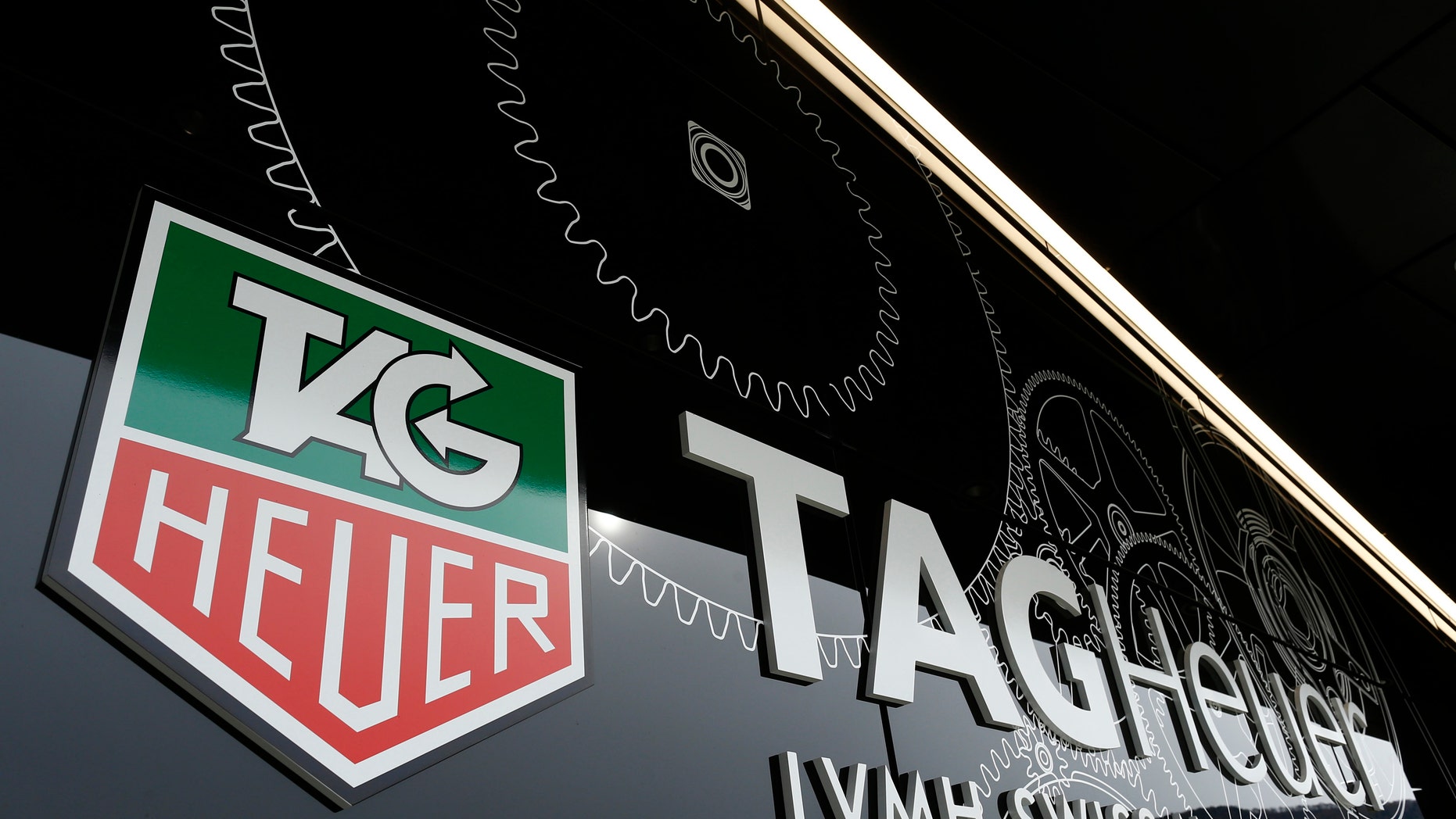The Tag Heuer logo is seen at the entrance of their new watch manufactory in Chevenez November 5, 2013. Swiss watch brand TAG Heuer expects single-digit sales growth this year and is aiming to outperform market growth estimated at about 5 percent in 2014, its head told Reuters on Tuesday. REUTERS/Ruben Sprich (SWITZERLAND - Tags: BUSINESS) - RTX1517Z