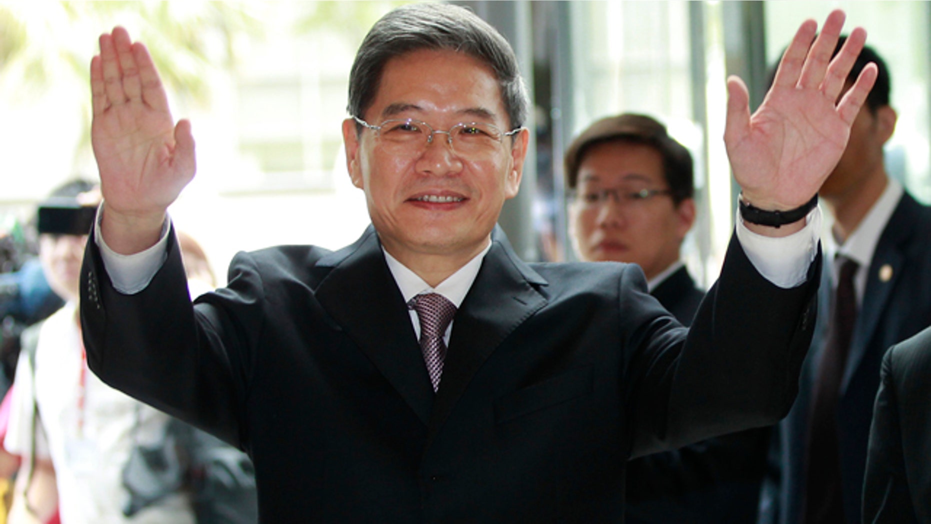 June 25, 2014: Zhang Zhijun, minister of Beijings Taiwan Affairs Office, waves at the airport hotel upon arrival in Taoyuan, Taiwan. China has sent Zhang, its first ever ministerial-level official to Taiwan for four days of meetings to rebuild ties with the self-ruled island that Beijing claims as its own, after mass protests in Taipei set back relations earlier this year. (AP Photo/Wally Santana)