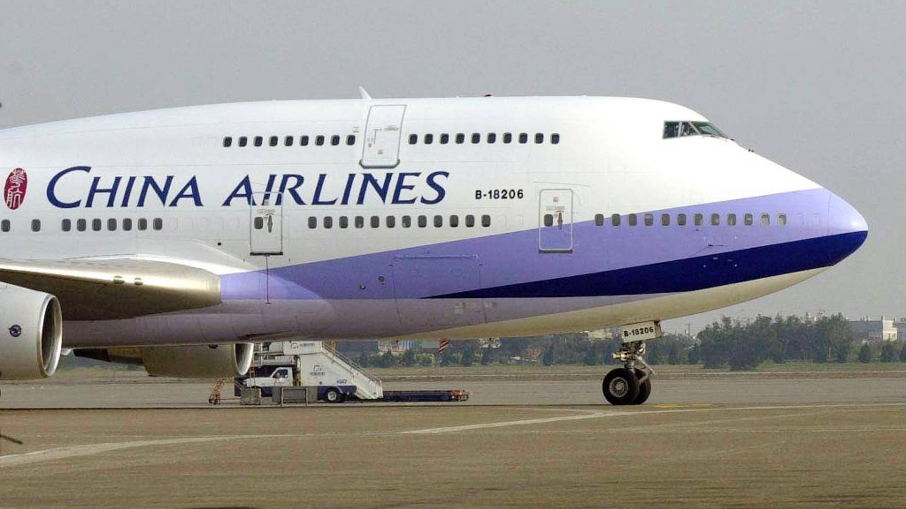 FILE - A China Airlines Boeing 747-400 sits on the tarmac at the Chiang Kai-shek International airport in Taoyuan, Taiwan.
