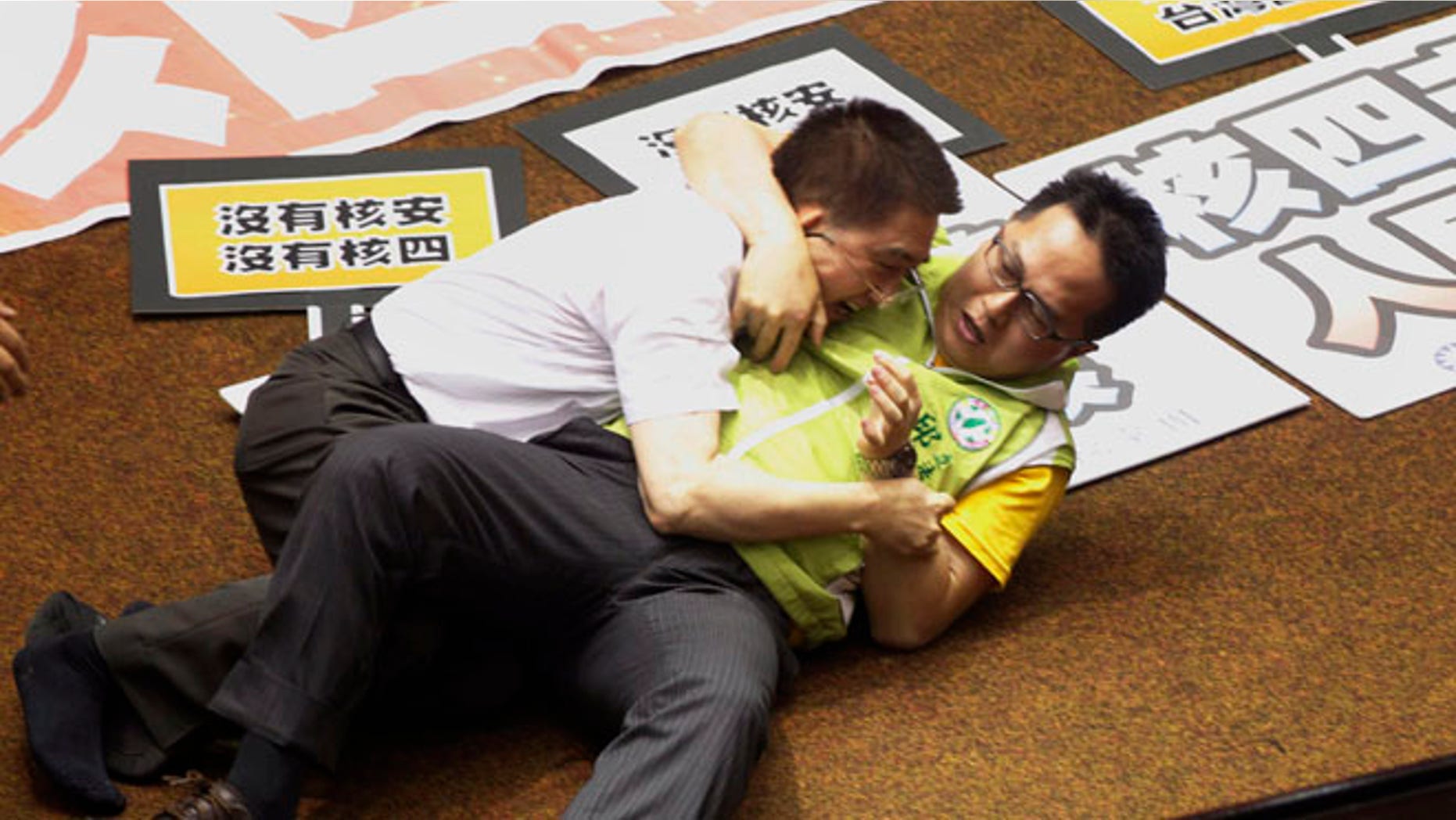 Aug 2, 2013: Ruling and opposition lawmakers fight each other on the legislature floor in Taipei, Taiwan.