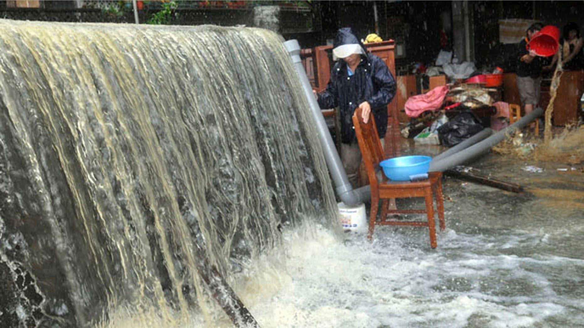 Oct. 22, 2010: Massive water and flood debris caused by rains from passing Typhoon Megi flow through a residential district in Ilan county, north eastern Taiwan.