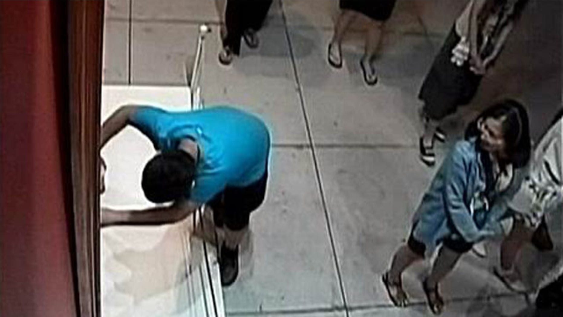 Aug. 23, 2015: In this image taken from security video, an unidentified 12-year-old boy trips and falls, damaging a 17th century Italian painting at an exhibition in Taipei, Taiwan. (Huashan 1914 Creative Park)