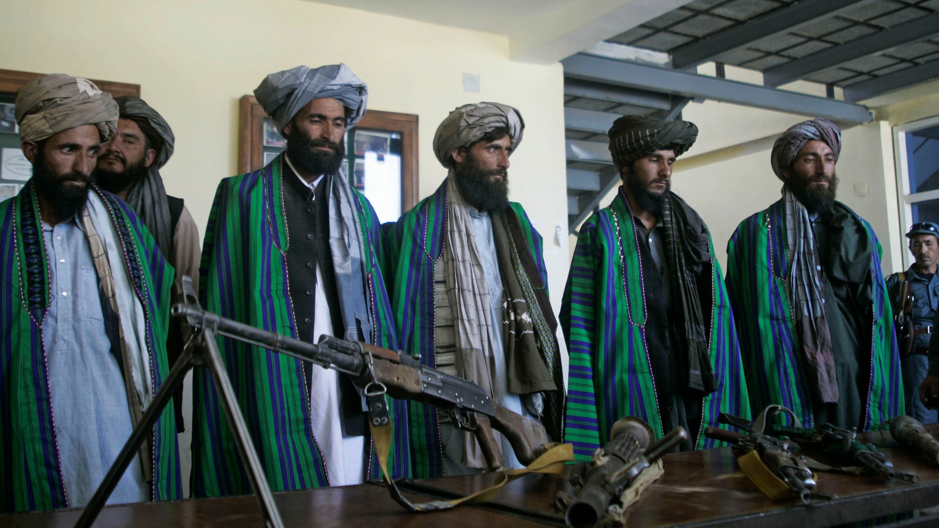 May 13, 2012: Former Taliban fighters hand over their weapons to Afghan police as part of a reconciliation process in Herat, Afghanistan.