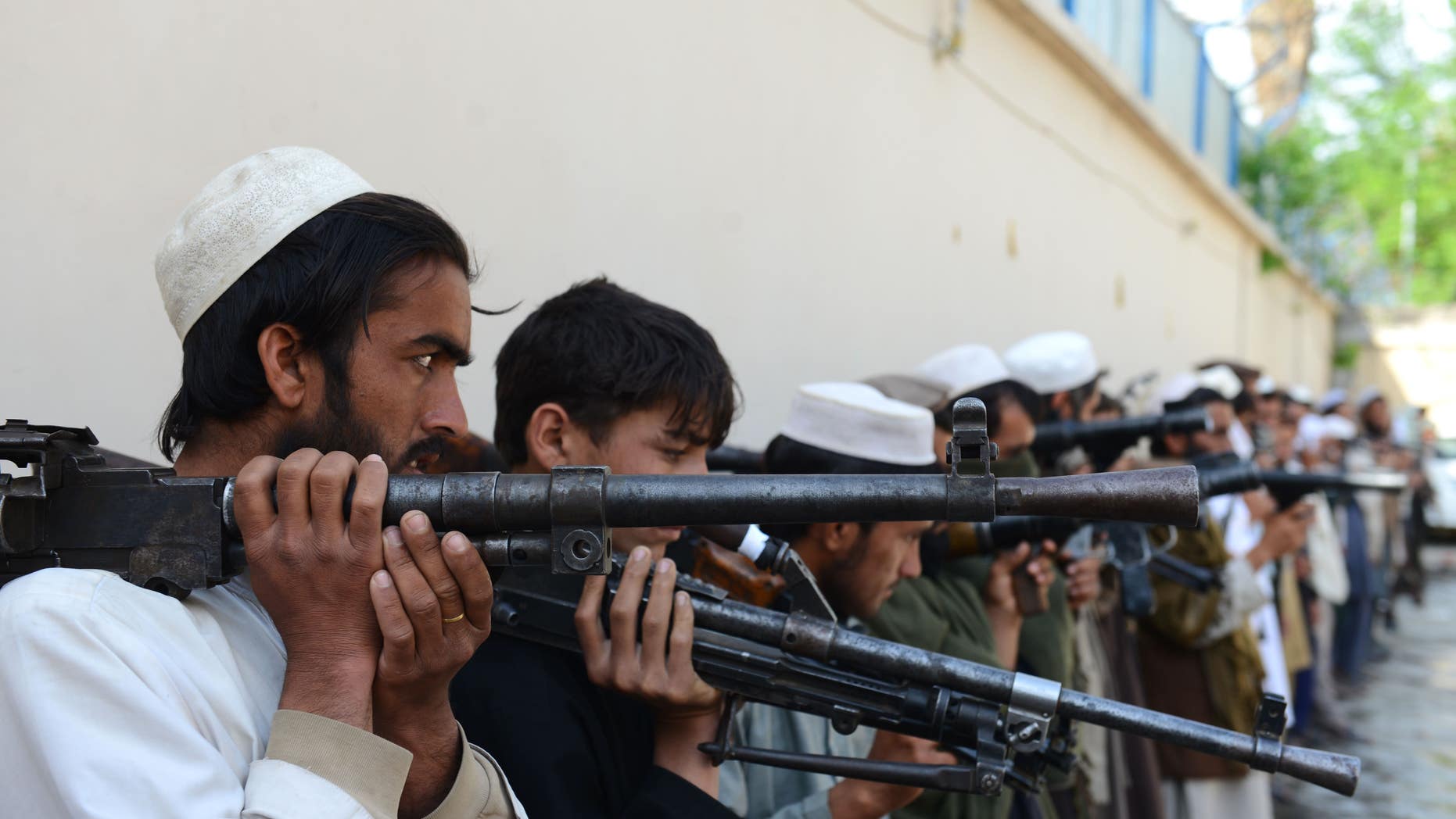 Taliban fighters hold their weapons before surrendering them to Afghan authorities in Jalalabad, Afghanistan, on March 27, 2016.