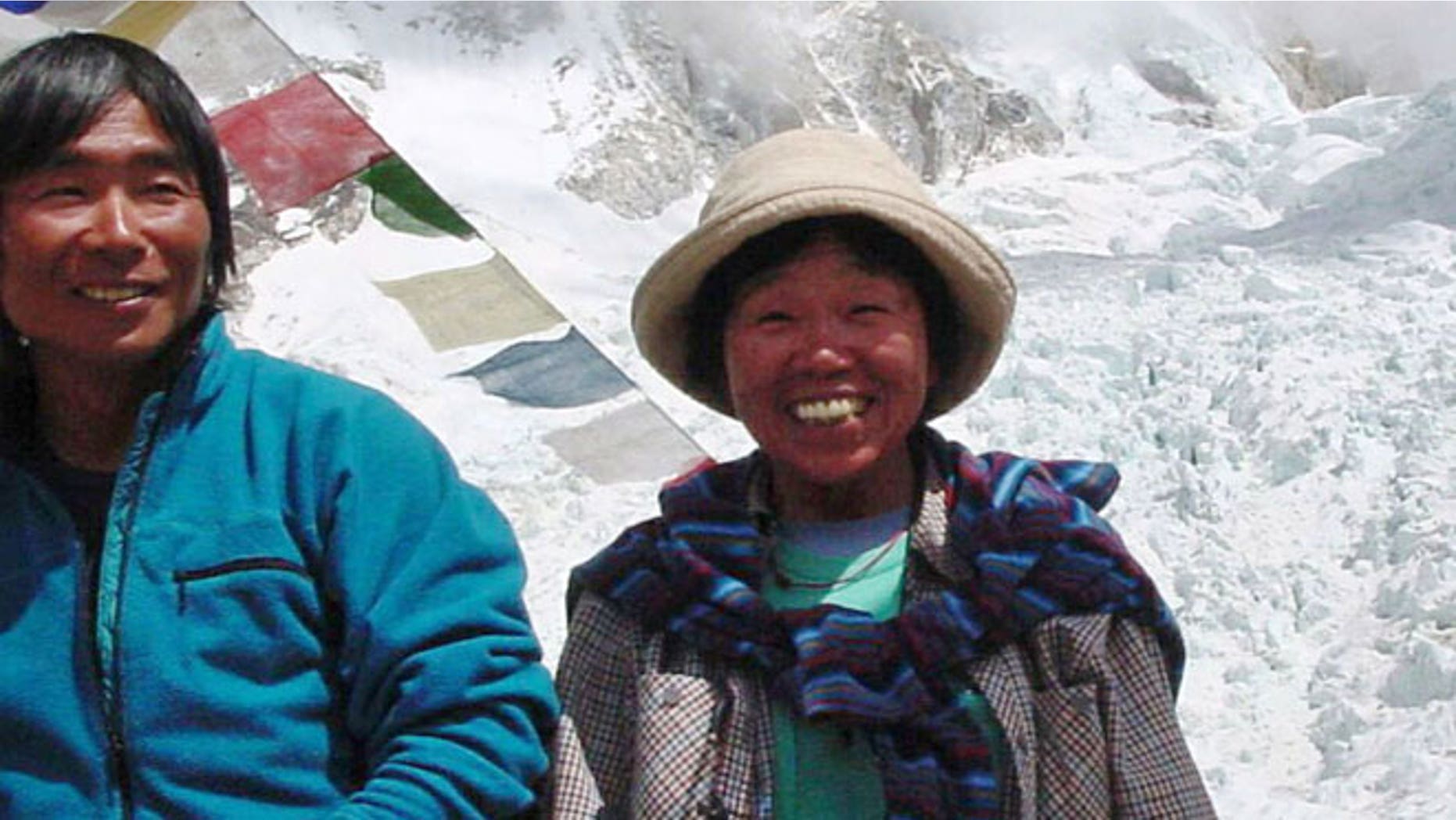 In this Thursday, May 9, 2002 file photo, Tamae Watanabe, right, of Japan poses with a photographer Noriyuki Muraguchi at a base camp on the foot of Mt. Everest in Nepal.