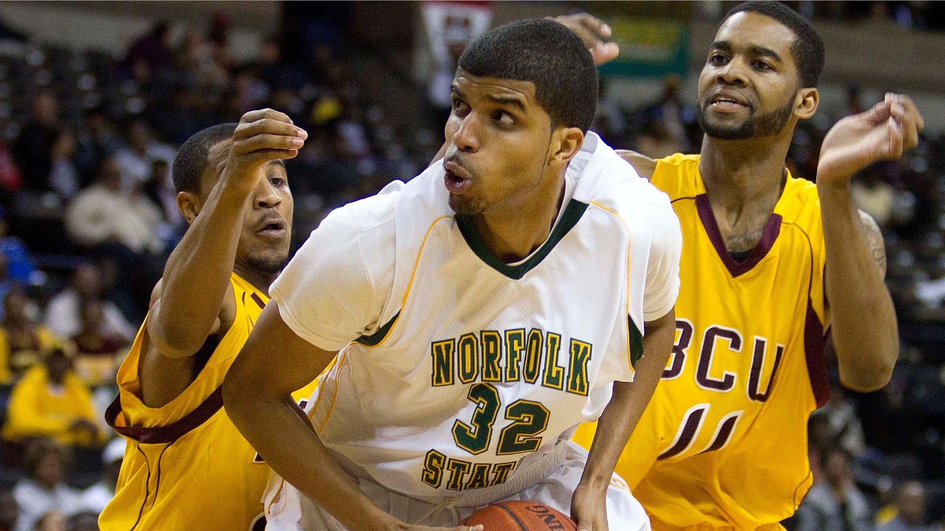 Norfolk State's Marcos Tamares (32) is guarded by Bethune-Cookman Kevin Dukes (21) and Javoris Bryant (11) during the first half of an NCAA college basketball game in the championship of the Mid-Eastern Athletic Conference tournament in Winston-Salem, NC., Saturday, March 10, 2012.