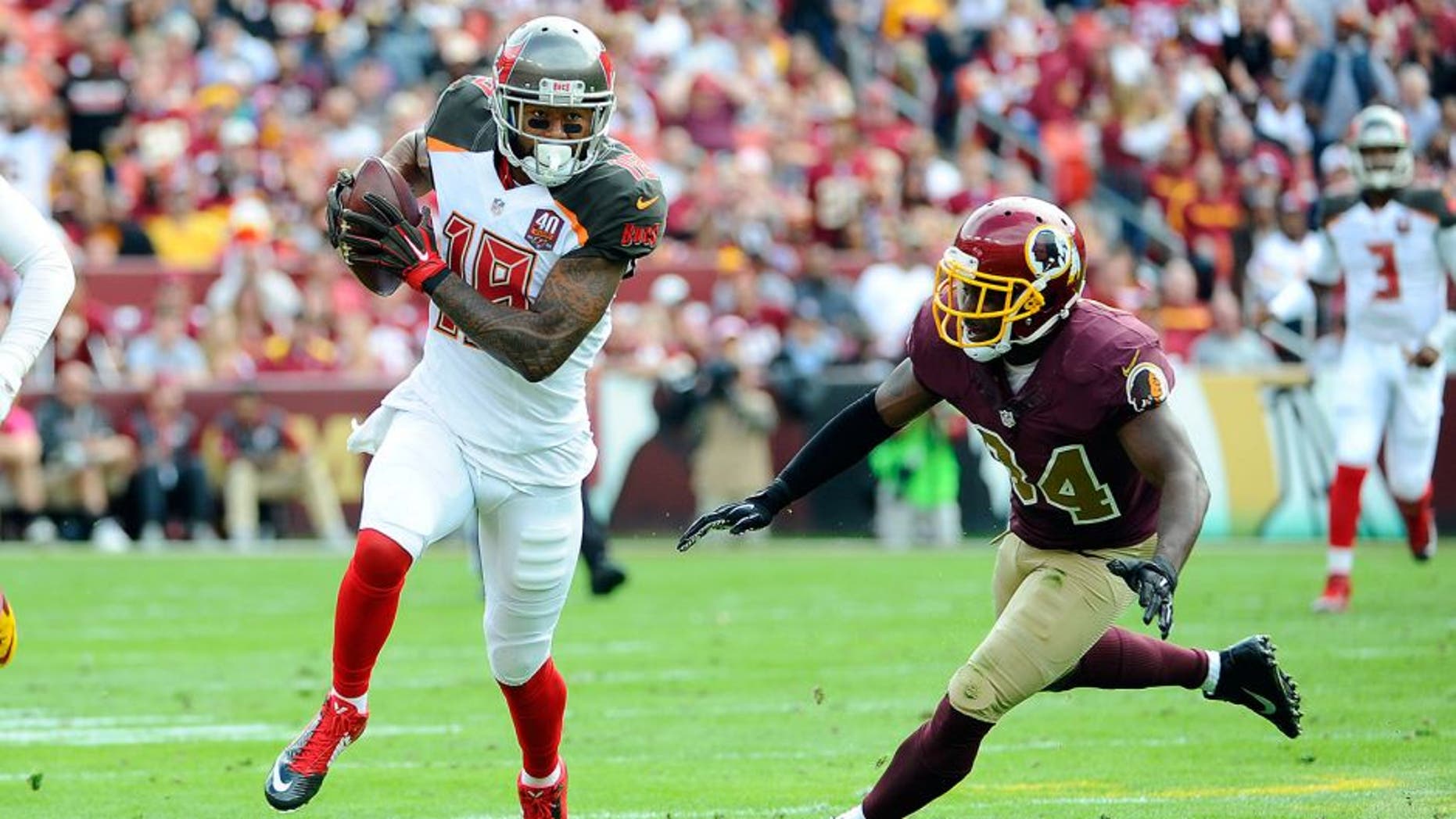 Oct 25, 2015; Landover, MD, USA; Tampa Bay Buccaneers wide receiver Louis Murphy (18) runs after the catch as Washington Redskins strong safety Trenton Robinson (34) looks on during the first half at FedEx Field. Mandatory Credit: Brad Mills-USA TODAY Sports
