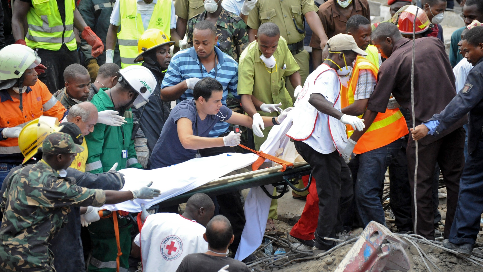 Mar. 29, 2013: Rescuers from the Tanzania Red Cross carry away a body from the rubble of a collapsed building in downtown Dar es Salaam, Tanzania.
