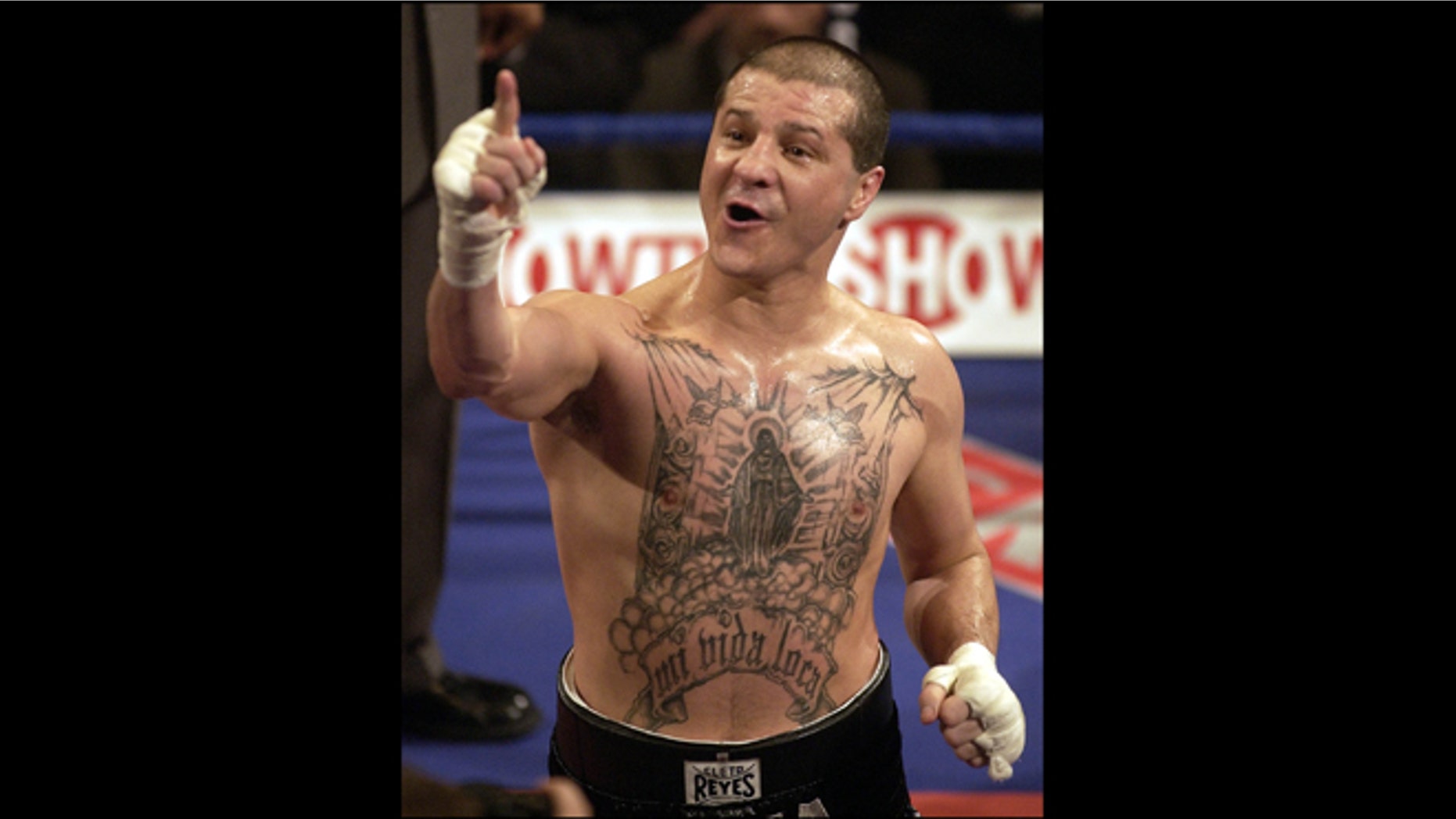 FILE - In this Jan. 19, 2002, file photo, Johnny Tapia celebrates after defeating Argentina's Eduardo Alvarez during the international featherweight boxing contest in London. Police Sunday May 27, 2012,say five-time world boxing champion Tapia has been found dead by a family member at his home in Albuquerque, N.M.(AP Photo/Adam Butler, File)