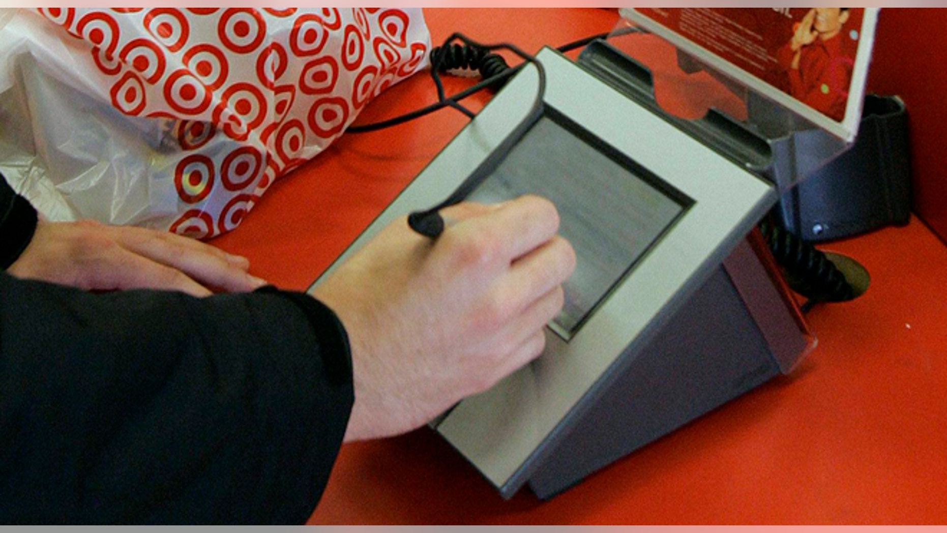 FILE - In this Jan. 18, 2008 file photo, a customer signs his credit card receipt at a Target store in Tallahassee, Fla. Target says that about 40 million credit and debit card accounts customers may have been affected by a data breach that occurred at its U.S. stores between Nov. 27, 2013, and Dec. 15, 2013. (AP Photo/Phil Coale, File)