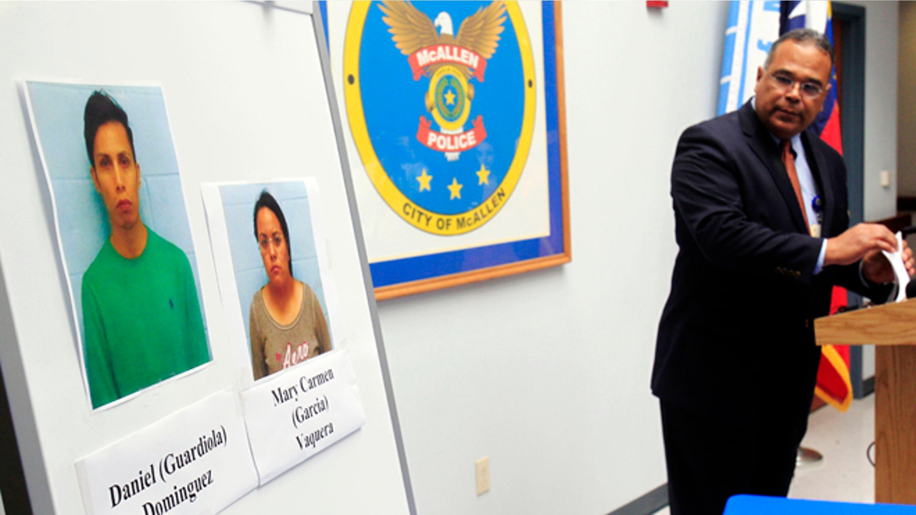 ADDS RECENT DEVELOPMENT- McAllen Police Chief Victor Rodriguez displays photos of Daniel Guardiola Dominiguez, left, and Mary Carmen Garcia, who were arrested Sunday after arriving at the border with 96 fraudulent credit cards that were produced using data stolen during the Target security breach late last year, Monday, Jan. 20, 2014, in McAllen, Texas. Rodriguez said Monday Jan. 20, 2014, that two Mexican citizens who were arrested at the border used account information stolen during the Target security breach to buy tens of thousands of dollars' worth of merchandise. But a federal official said later there currently was no connection between the arrests and the retailer's credit card data theft. (AP Photo/The Monitor, Gabe Hernandez) MAGS OUT; TV OUT (AP Photo/The Monitor, Gabe Hernandez) MAGS OUT; TV OUT