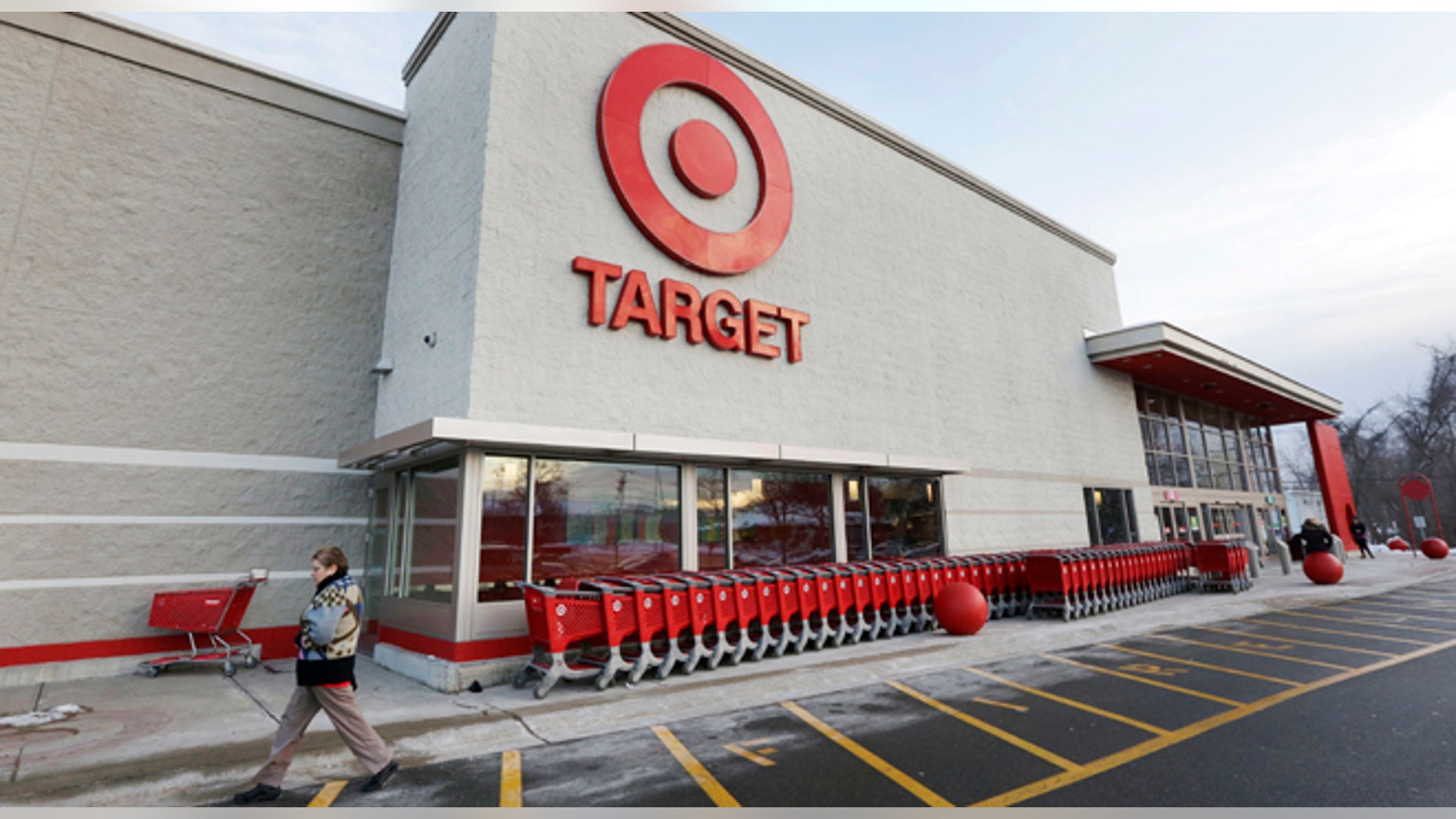 FILE - In this Dec. 19, 2013, file photo, a passer-by walks near an entrance to a Target retail store in Watertown, Mass. The security breach that hit Target Corp. during the crucial holiday season seemed to be part of a broader and highly sophisticated scam that affected several retailers, says a report published by a global cyber intelligence firm that works with the U.S. Secret Service and the Department of Homeland Security, Thursday, Jan. 16, 2014. (AP Photo/Steven Senne, File)