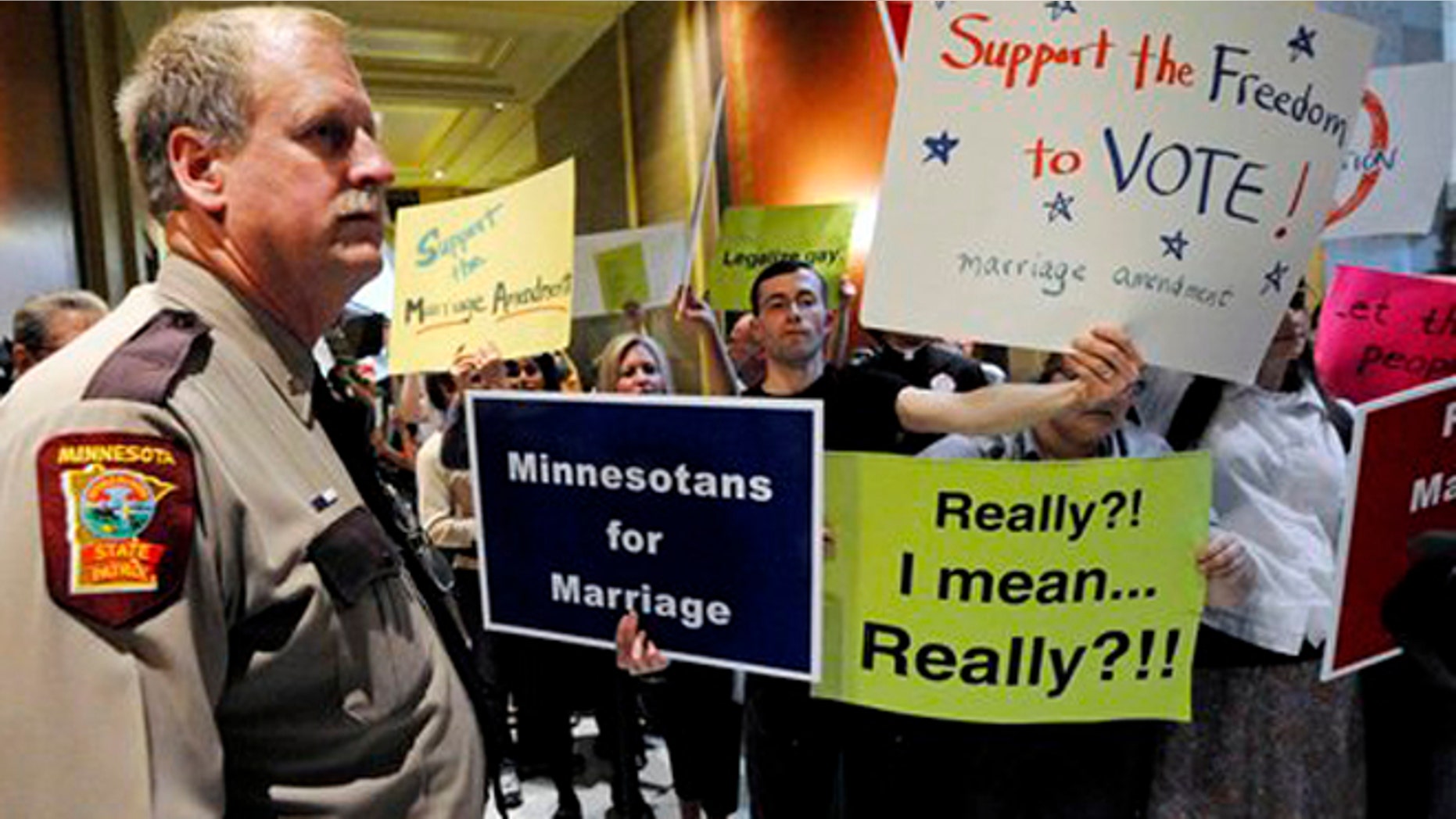 FILE: May 2011: A state trooper stands by as demonstrators on both sides of the gay marriage issue gather outside the Minnesota House in St. Paul, Minn.