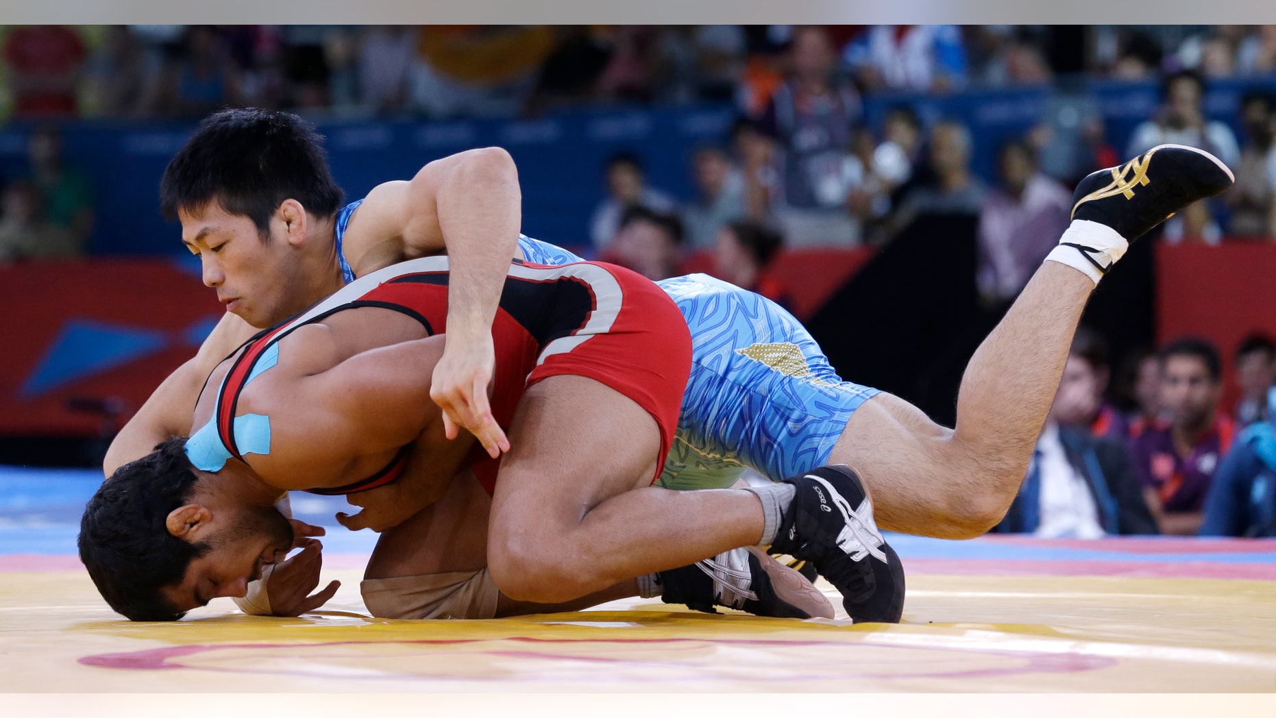 Aug. 12, 2012: Sushil Kumar of India competes with Tatsuhiro Yonemitsu of Japan (in blue) during their 66-kg freestyle wrestling gold medal match at the 2012 Summer Olympics, Sunday, in London.