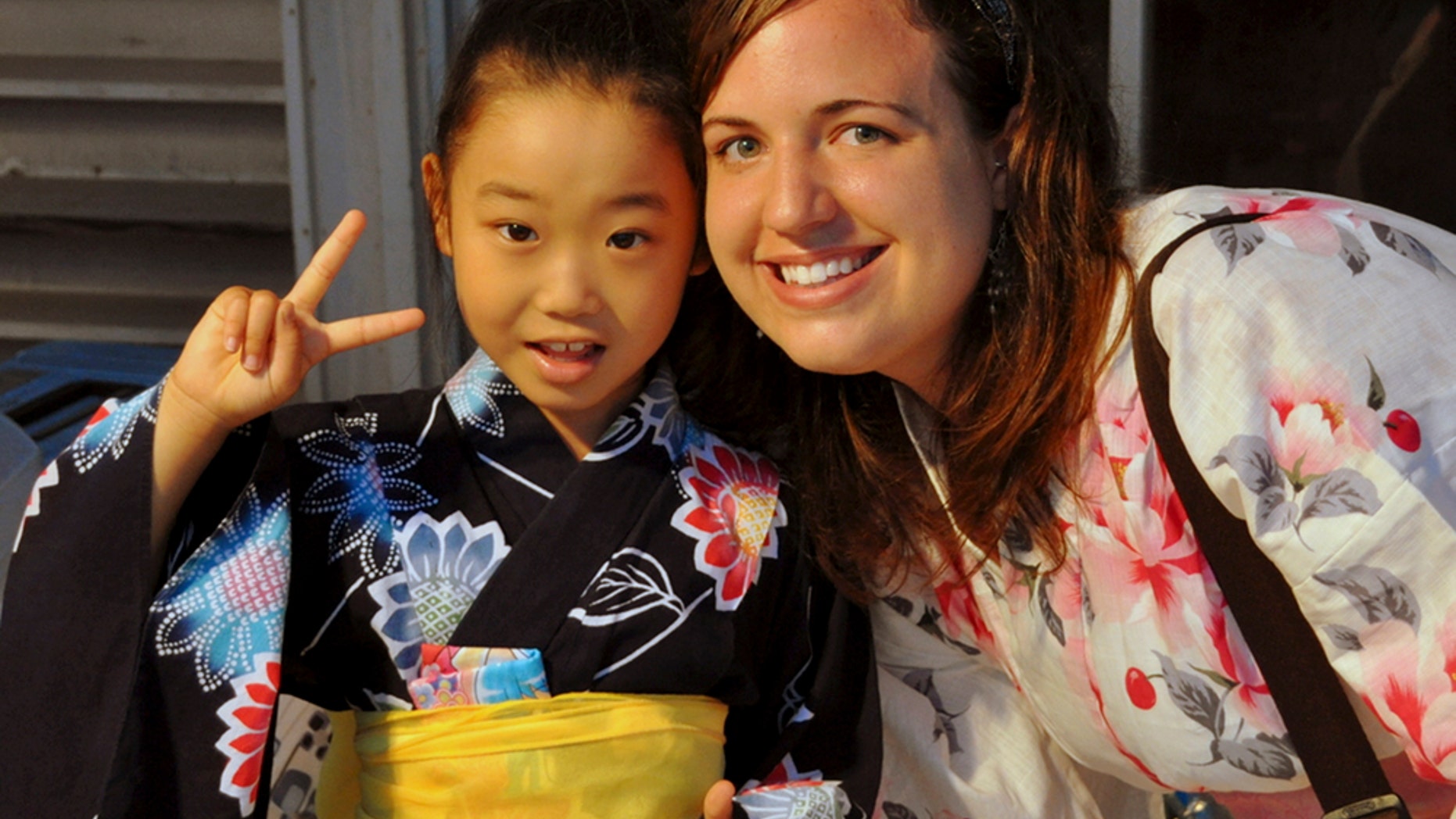 In this July 17, 2010 photo provided the Anderson family, Taylor Anderson, right, poses with one of her students in Ishinomaki, Japan.