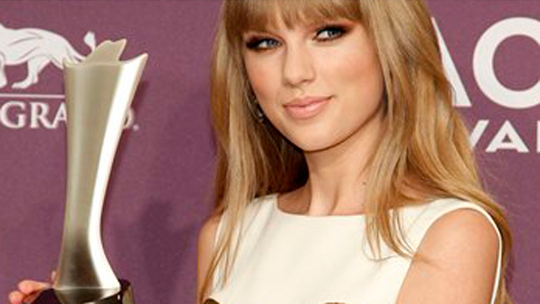 April 1, 2012: Taylor Swift poses backstage with the award for entertainer of the year at the 47th Annual Academy of Country Music Awards.