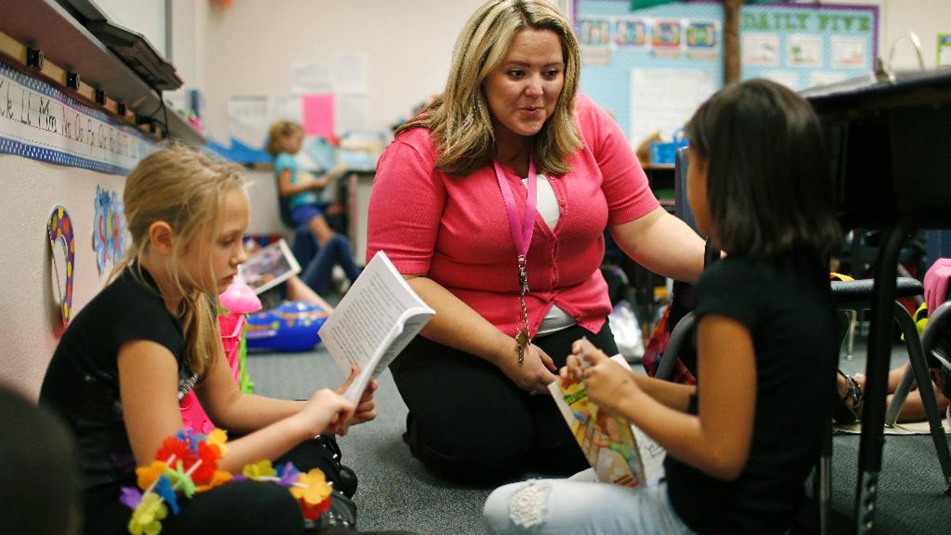 Sept. 10, 2015: Tia Martin, center, works with Izabel Martinez, left, and Ashlyn Dowding in a third-grade class at Ulis Elementary School in Henderson, Nev.