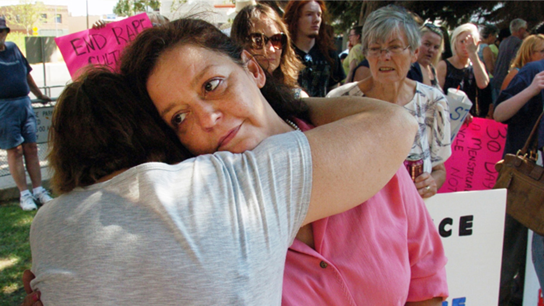 Aug 29, 2013: Auliea Hanlon receives a hug from a supporter during a rally in which protesters called for the resignation of a judge who presided over the trial of a former teacher who raped Hanlon's daughter.