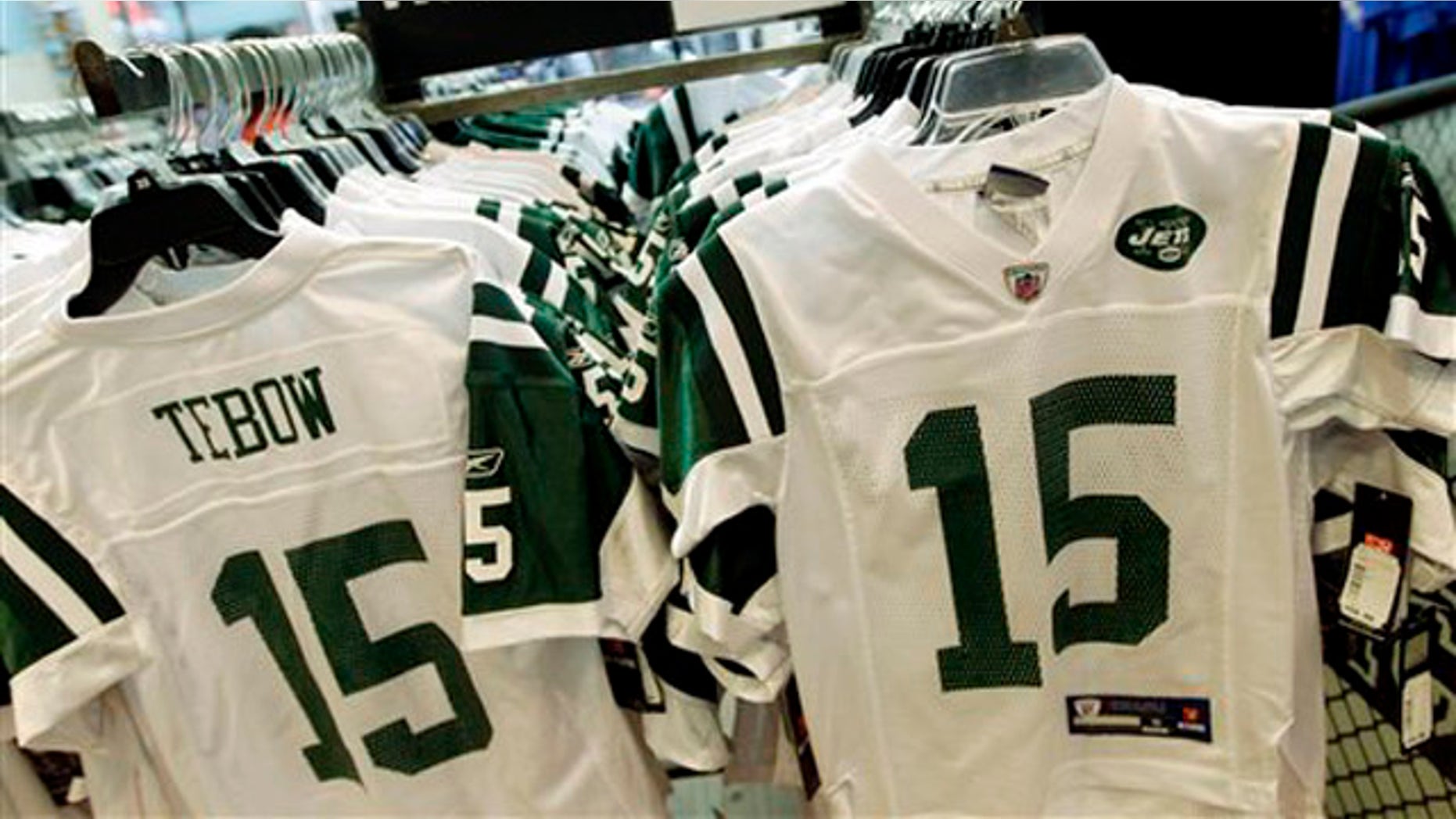 In this file photo, Reebok-branded New York Jets football jerseys with the name and number of Jets quarterback Tim Tebow are displayed at a Modell's store in New York.