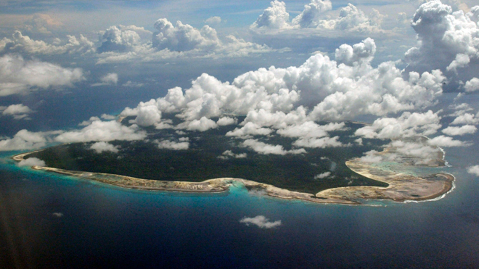 Clouds hang over the North Sentinel Island, in India's southeastern Andaman and Nicobar Islands. India used heat sensors on flights over hundreds of uninhabited Andaman Sea islands Friday, March 14, 2014, and will expand its search for the missing Malaysia Airlines jet farther west into the Bay of Bengal, officials said. The Indian-controlled archipelago that stretches south of Myanmar contains 572 islands covering an area of 720-by-52 kilometers. Only 37 are inhabited, with the rest covered in dense forests.