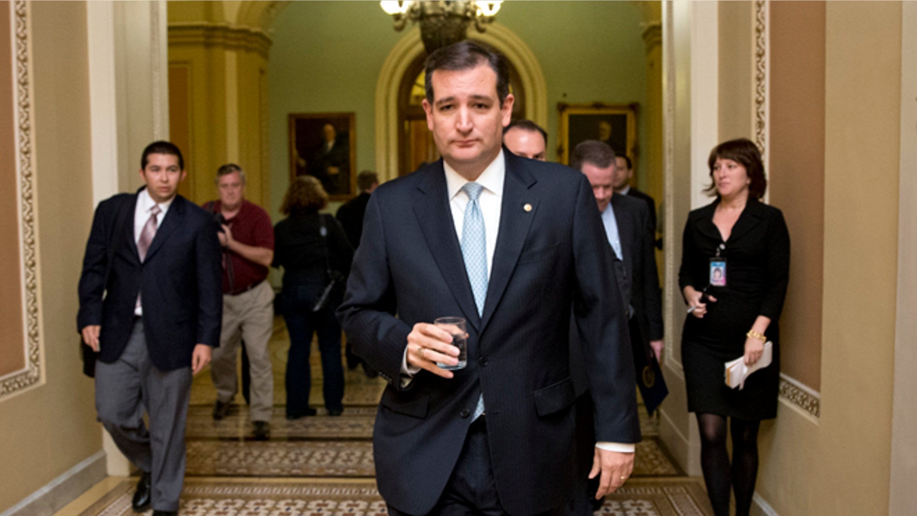 FILE - In this Oct. 16, 2013, file photo, Tea party conservative Sen. Ted Cruz, R-Texas, walks to a meeting as the Senate prepares to vote on a measure to avert a threatened Treasury default and reopen the government after a partial, 16-day shutdown, at the Capitol in Washington. Cruz took nothing short of a victory lap in his state of Texas this week, appearing before crowds that overlooked the fact that the Republican who led the charge to kill money for President Barack Obamaâs health care law had failed. Now heâs coming to Iowa, where Republicans have the first say in the presidential race, and will view him much more skeptically. (AP Photo/J. Scott Applewhite, File)