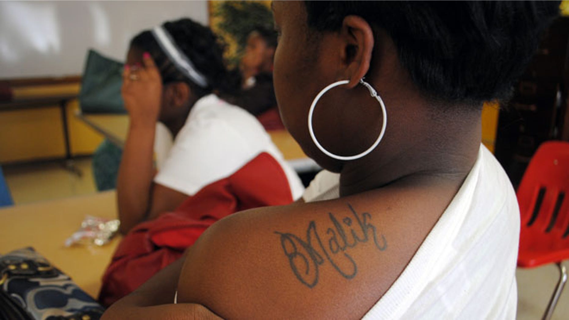 Shalendrick Tribble, 19, of in Marks, Miss., shows off a tattoo of her son's name in a classroom at Madison S. Palmer High School in Marks. (AP Photo/Laura Tillman)