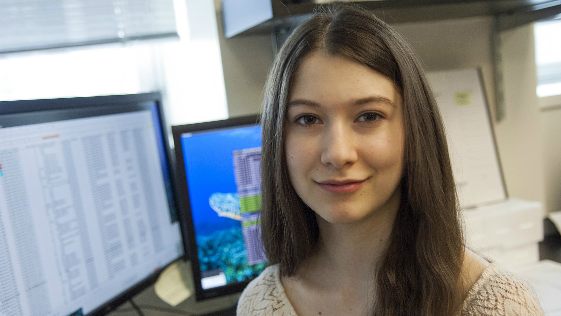 This handout photo shows Elana Simon, 18, of New York, pictured in a laboratory at The Rockefeller University in New York. The teen survivor of a rare liver cancer spearheaded a study, published Thursday in the journal Science, that led a team of researchers to find a gene flaw involved with the disease.