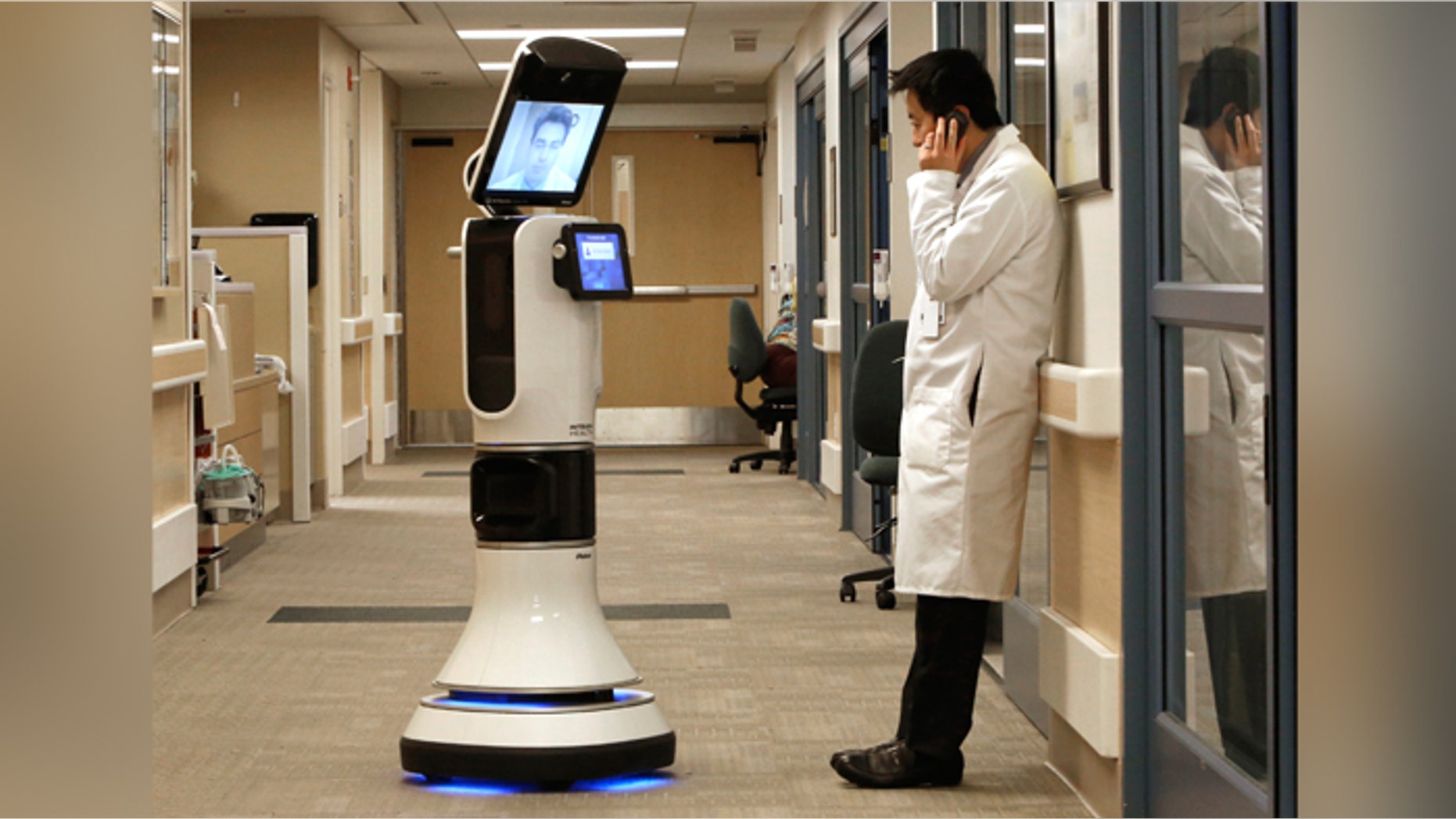 Dr. Alan Shatzel, medical director of the Mercy Telehealth Network, is displayed on the monitor RP-VITA robot as he waits to confer with Dr. Alex Nee at Mercy San Juan Hospital in Carmichael, Calif. The robots enable physicians to have "beam" themselves into hospitals to diagnose patients and offer medical advice during emergencies.