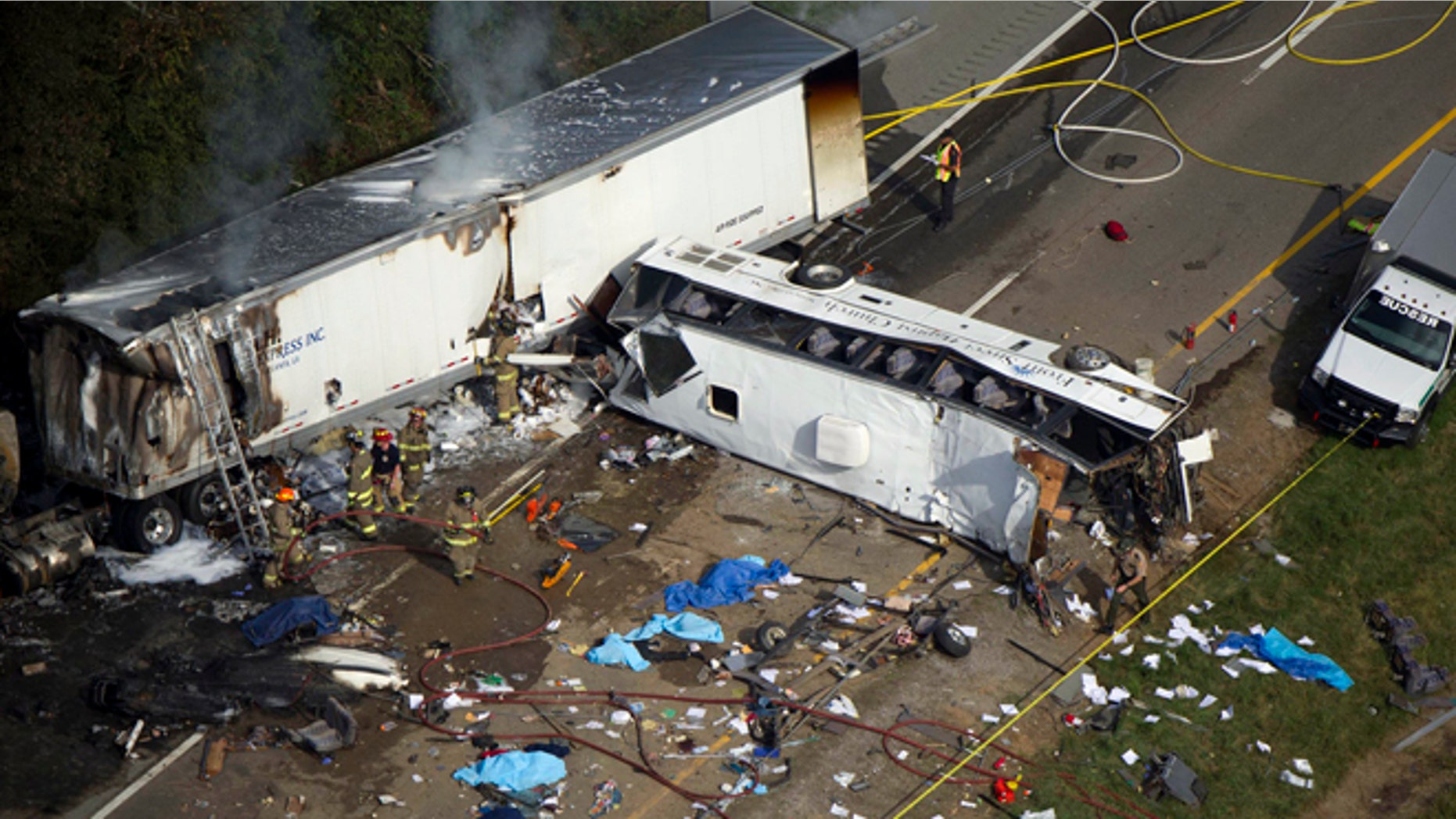 Emergency workers respond to a crash involving a passenger bus and a tractor-trailer near Dandridge, Tenn., on Wednesday, Oct. 2, 2013.