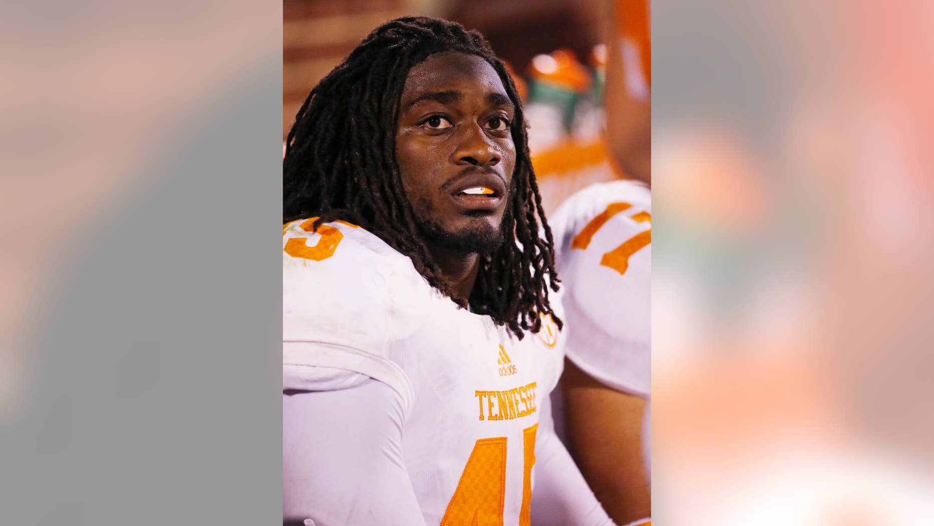 FILE - In this Sept. 13, 2014, file photo,Tennessee linebacker A.J. Johnson sits on the bench during an NCAA college football game between Tennessee and Oklahoma in Norman, Okla. Tennessee has suspended leading tackler Johnson and defensive back Michael Williams amid a sexual assault investigation. The school announced Monday, Nov. 17 on the football program’s Twitter account that both players had been suspended “from all team-related activities” without going into further details. (AP Photo/Sue Ogrocki, File)