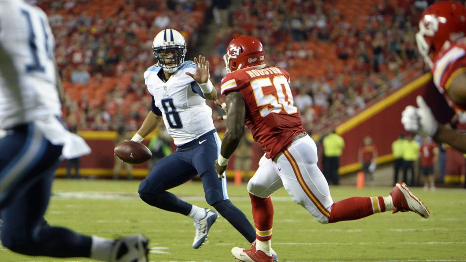 Aug 28, 2015; Kansas City, MO, USA; Tennessee Titans quarterback Marcus Mariota (8) is pressured by Kansas City Chiefs outside linebacker Justin Houston (50) in the first half at Arrowhead Stadium. Mandatory Credit: John Rieger-USA TODAY Sports