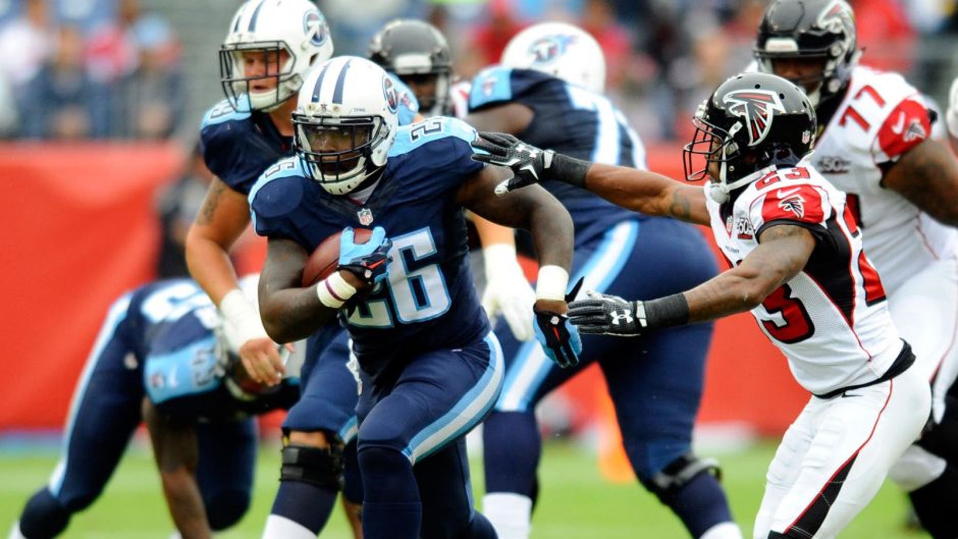 Oct 25, 2015; Nashville, TN, USA; Tennessee Titans running back Antonio Andrews (26) runs for a first down during the first half against the Atlanta Falcons at Nissan Stadium. Mandatory Credit: Christopher Hanewinckel-USA TODAY Sports