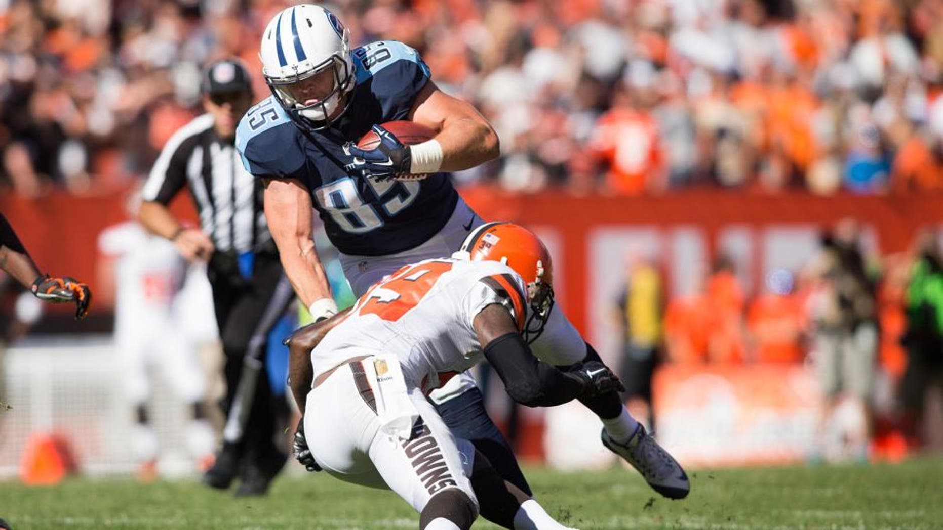 Sep 20, 2015; Cleveland, OH, USA; Tennessee Titans tight end Chase Coffman (85) gets tackled by Cleveland Browns free safety Tashaun Gipson (39) during the fourth quarter at FirstEnergy Stadium. Mandatory Credit: Scott R. Galvin-USA TODAY Sports
