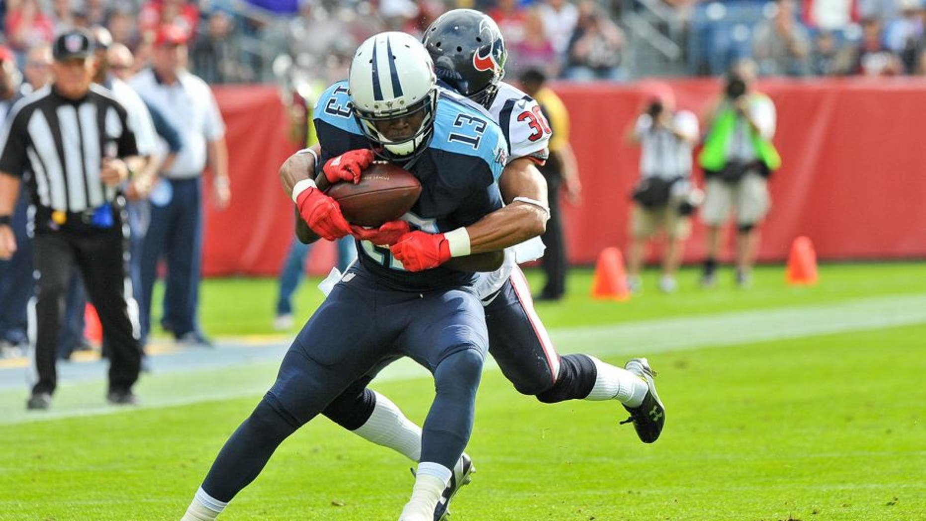 Dec 27, 2015; Nashville, TN, USA; Tennessee Titans wide receiver Kendall Wright (13) is tackled by Houston Texans strong safety Kevin Johnson (30) during the first half at Nissan Stadium. Mandatory Credit: Jim Brown-USA TODAY Sports