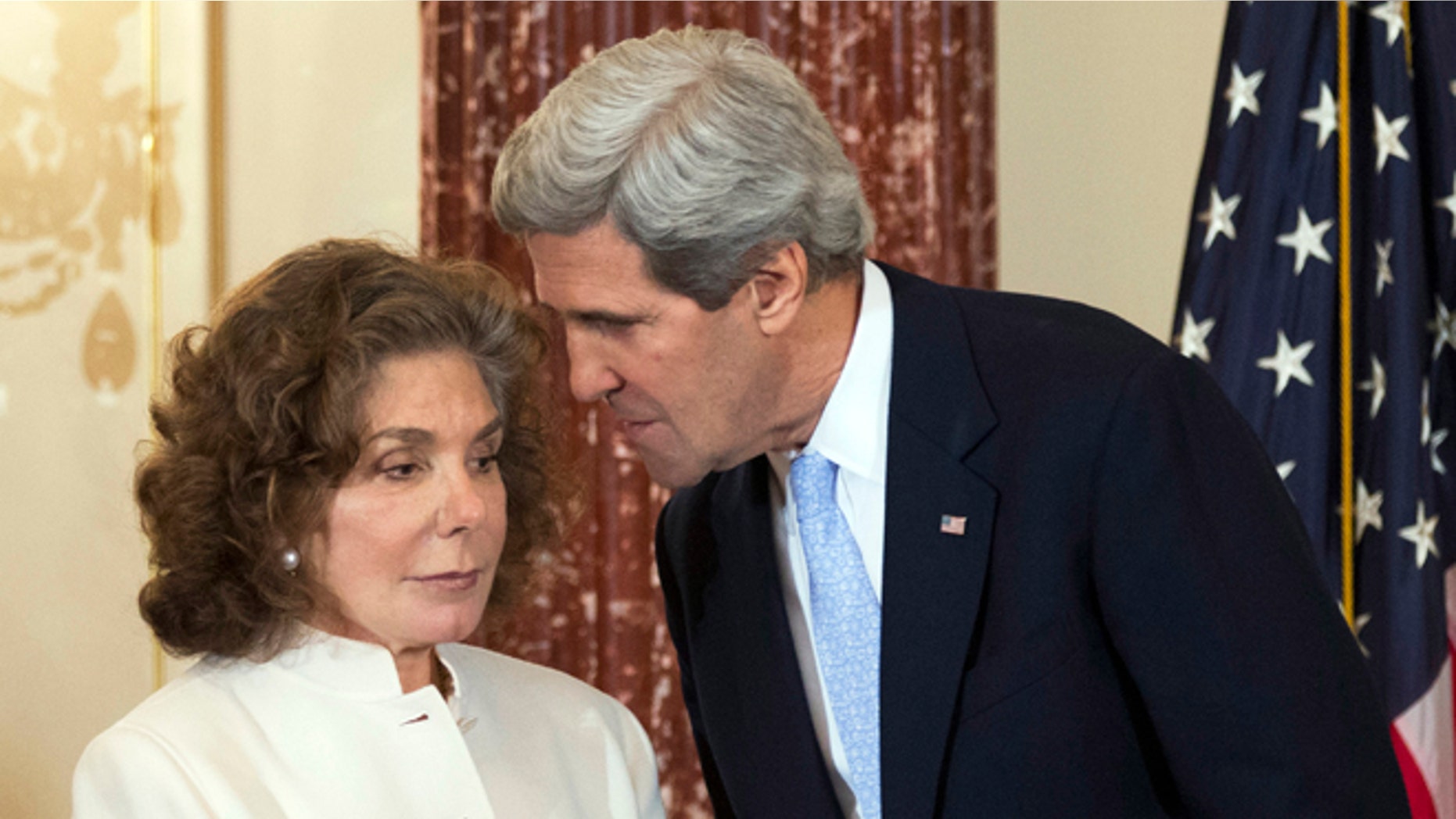 Feb. 6, 2013: In this file photo, Secretary of State John Kerry, right, whispers to his wife Teresa Heinz Kerry during the ceremonial swearing-in for him as the 68th secretary of state, at the State Department in Washington.